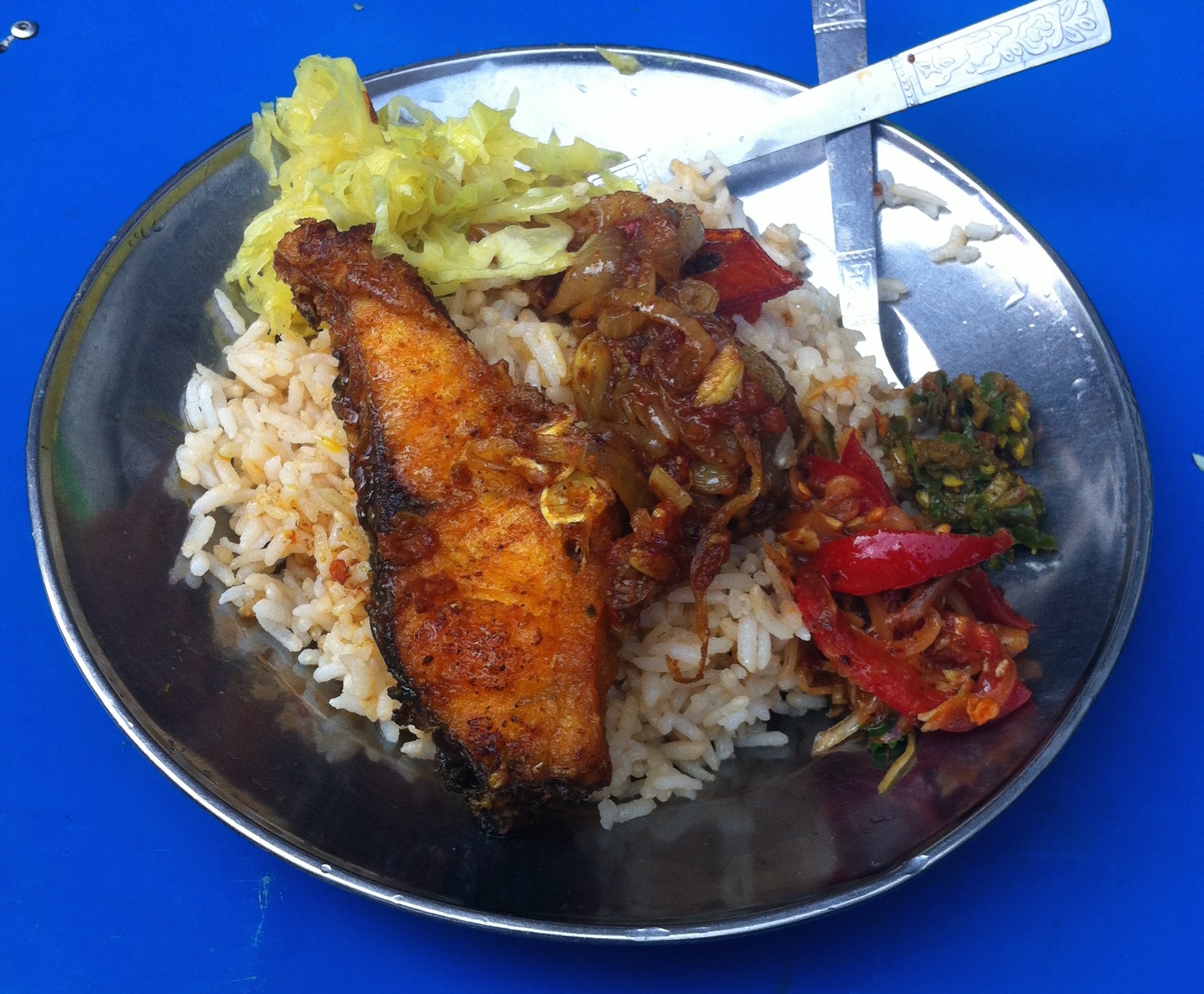 Fish with two curries, cabbage and a chili/fish paste compote. I go to this stand every morning for breakfast. $1