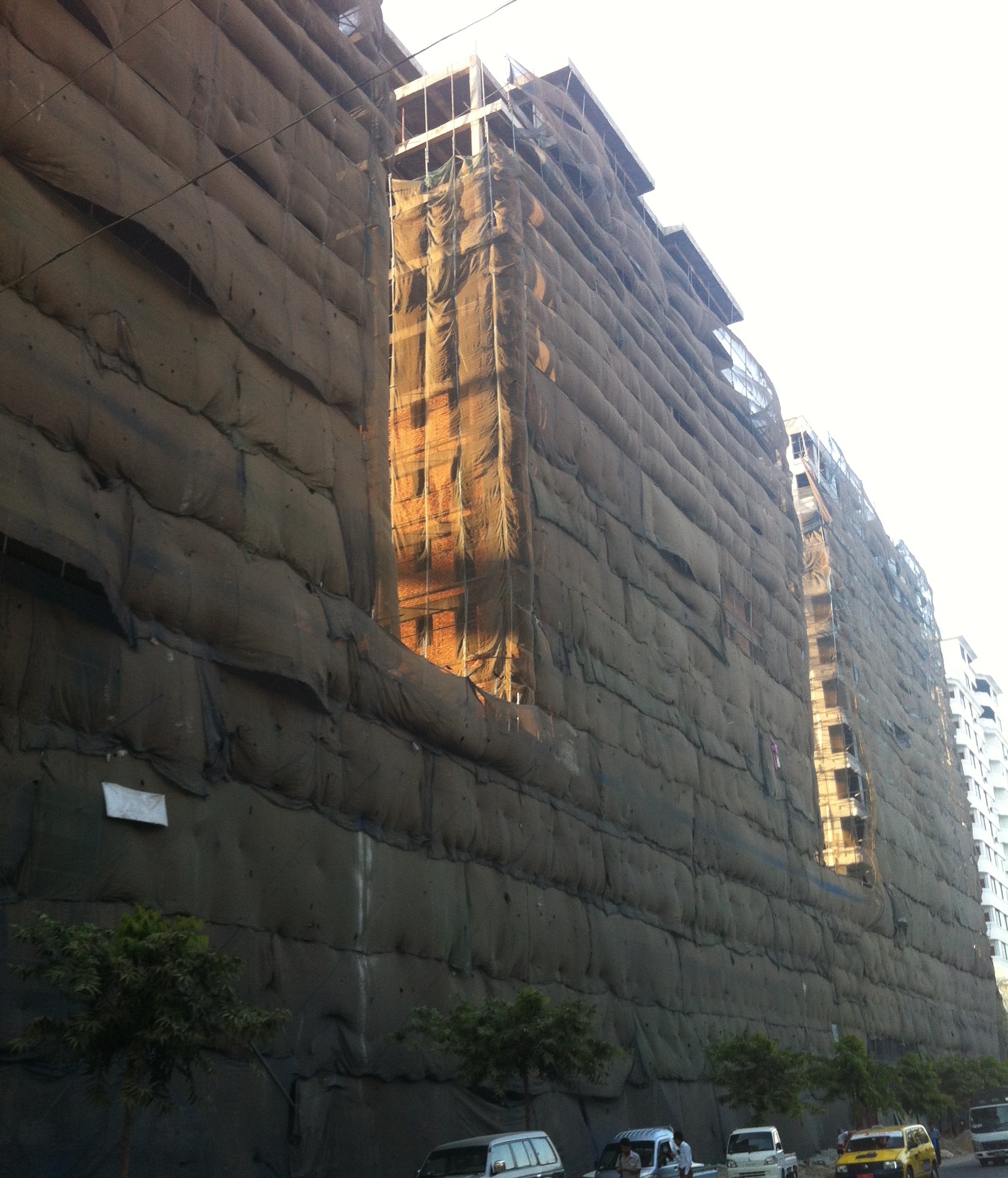 A building under construction, shrouded and looking like a Claes Oldenburg soft sculpture