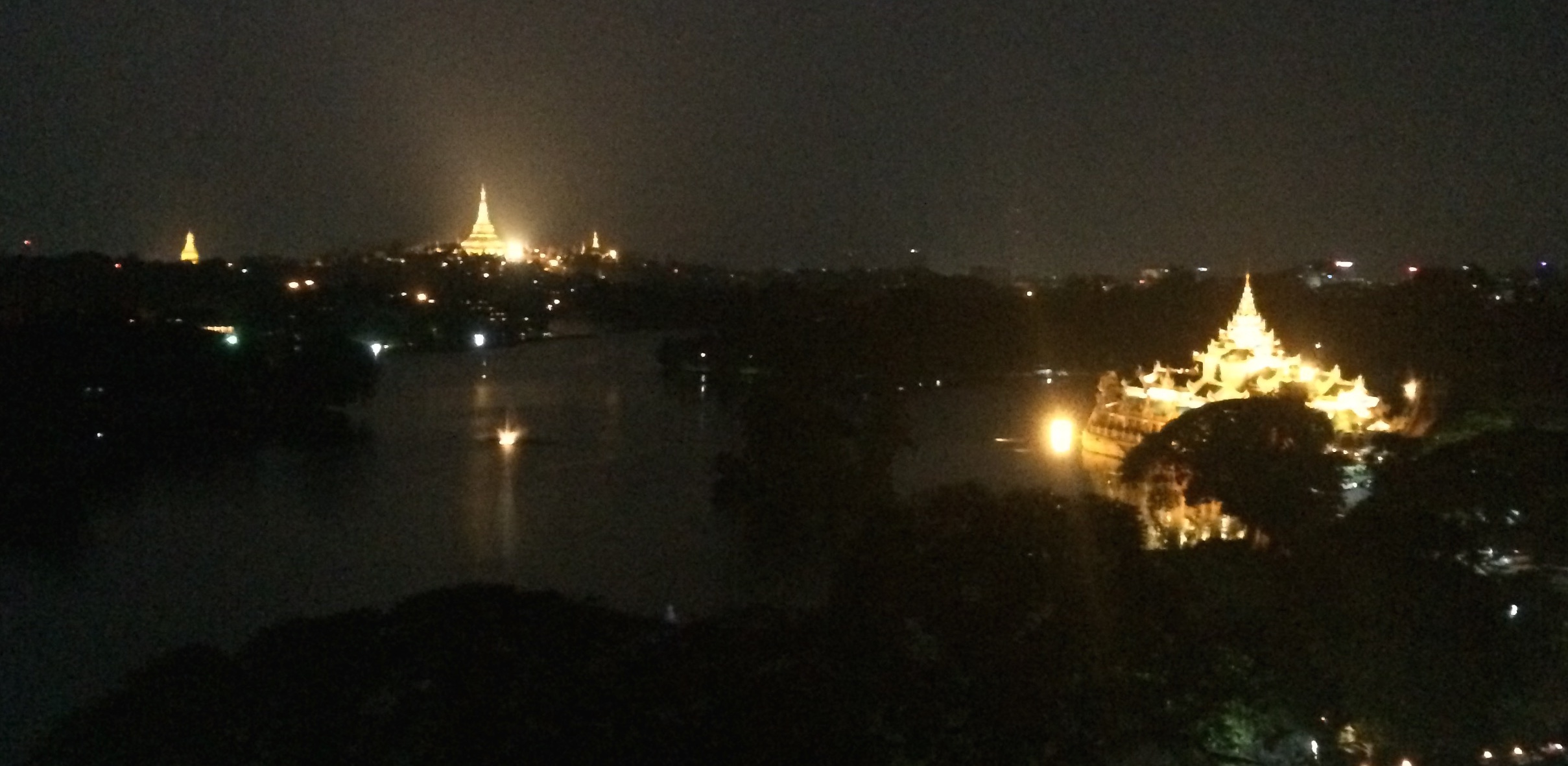 Schwedagon pagoda (left) and Kandawgyi Palace Hotel (right) from a rooftop hotel bar