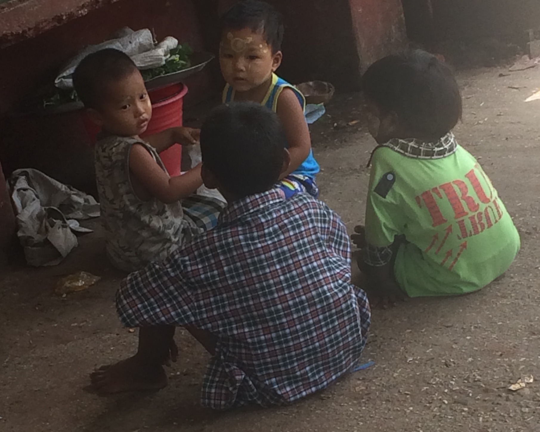 The child in light blue has tanaka intricately painted on his face.