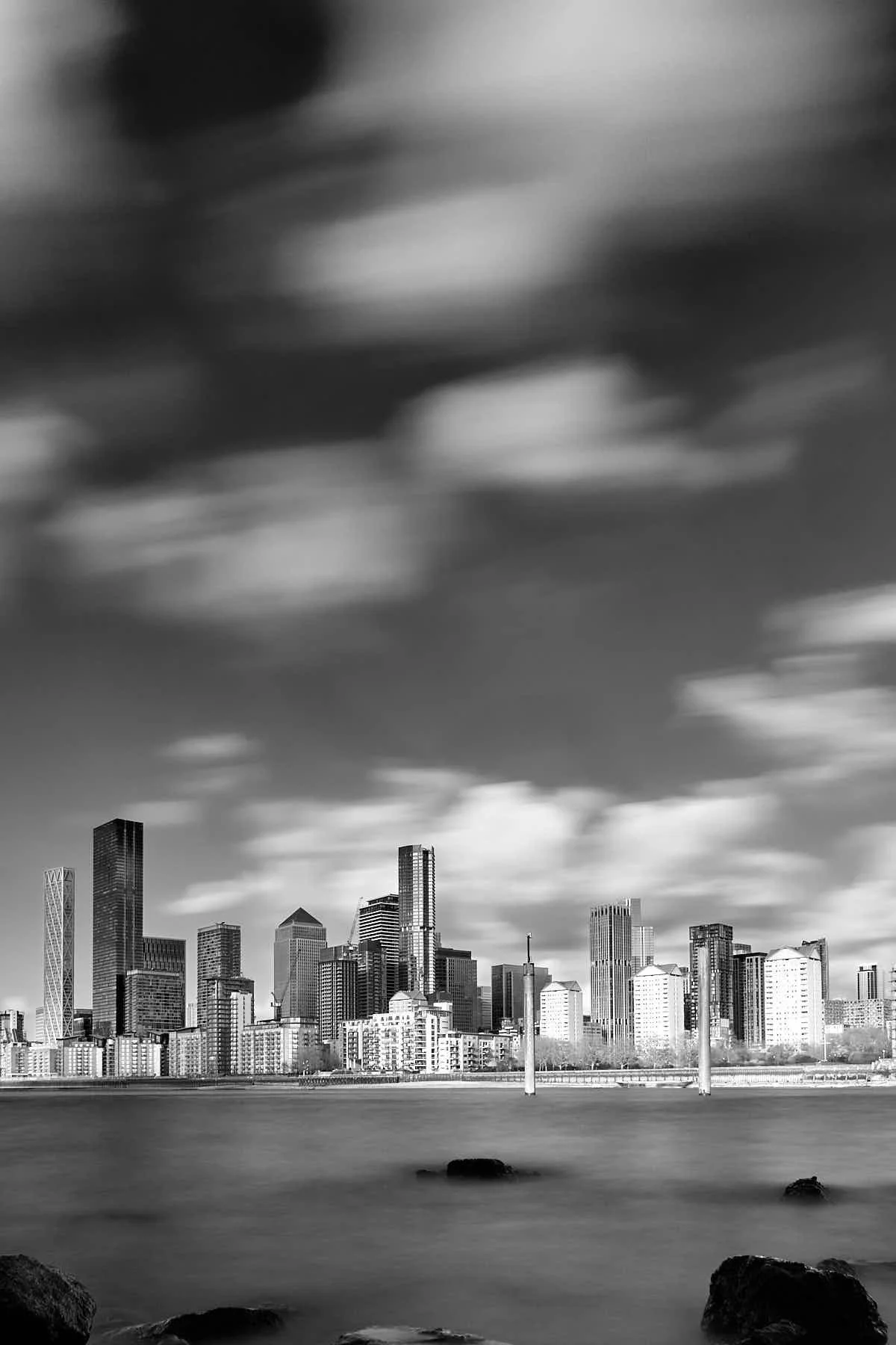 long exposure black and white image of the London Docklands seen across the river Thames