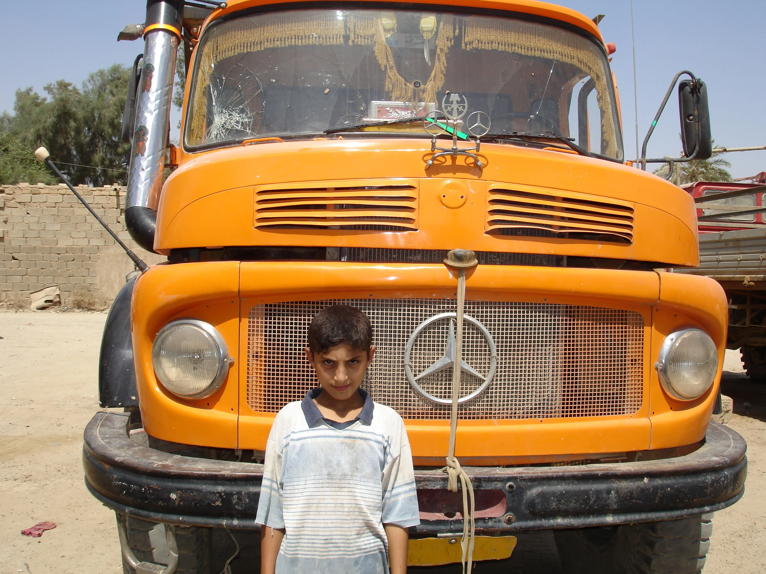 sheik's son in front of truck.JPG