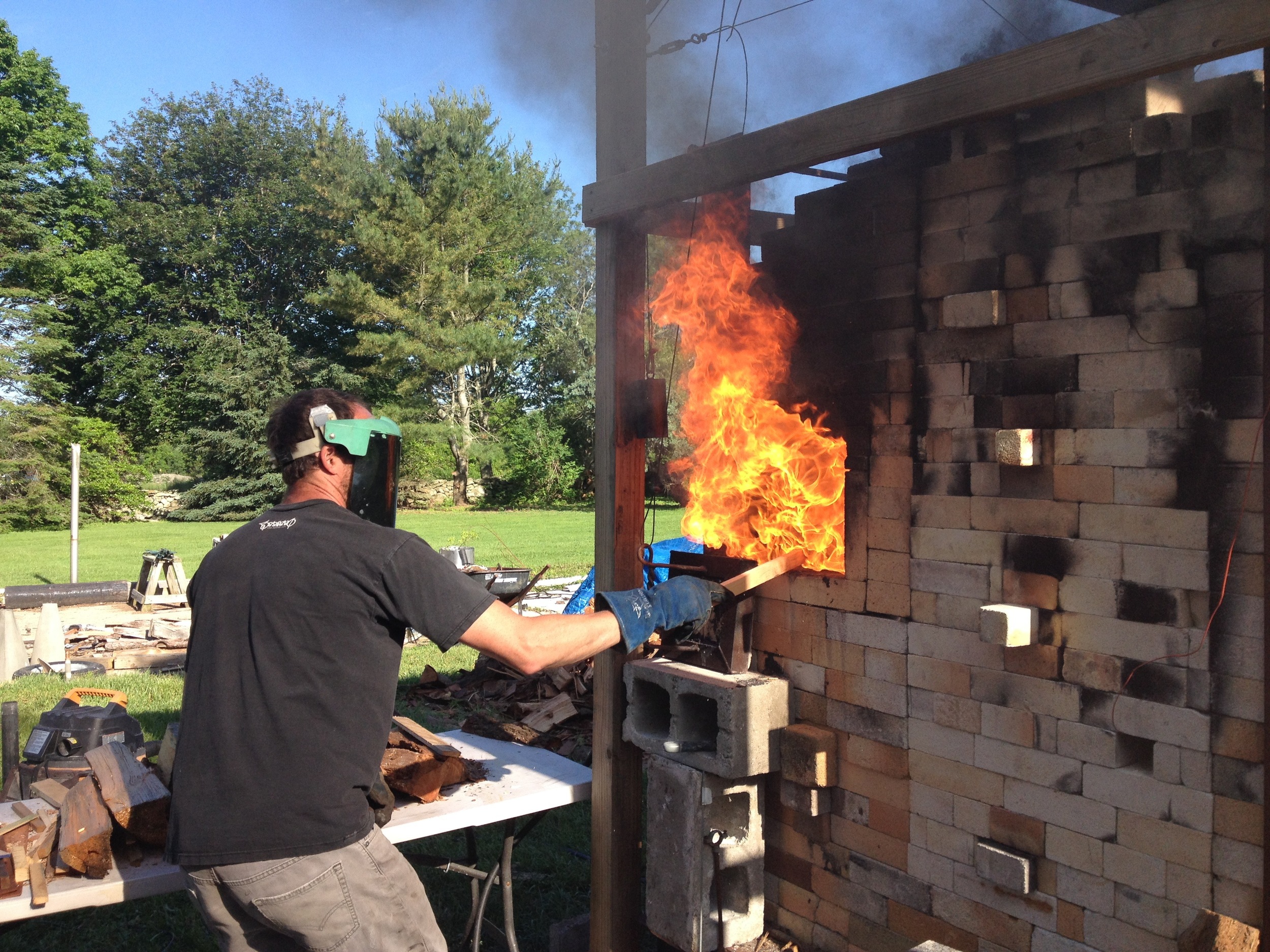 Charlie firing the hybrid wood/soda/gas kiln he built at his home in Little Compton.