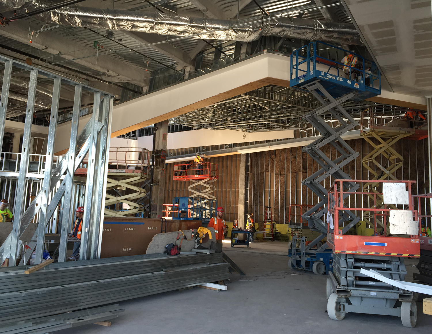 The wall at the back of this area (directly behind the rear scissor lift) is the temporary wall opposite my installation wall. It is scheduled to be removed in one week, leaving this area open. When complete, one will be able to view my mural from a distance of about 60 feet.