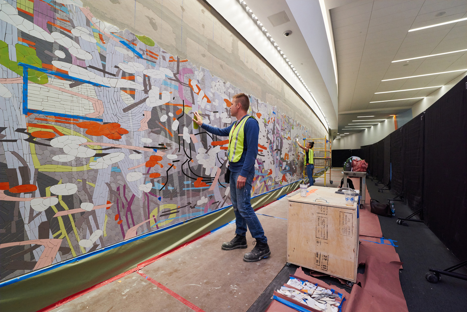 Mike from Mosaika checking the surface of the mural during installation.