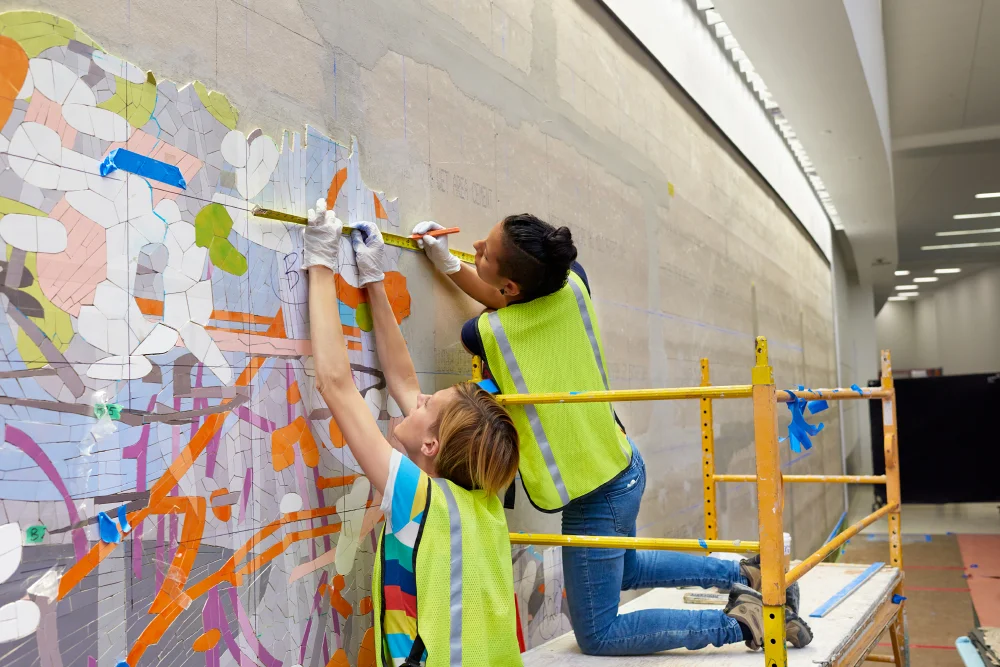Emily and Valentina align a section of the mosaic to the grid. 