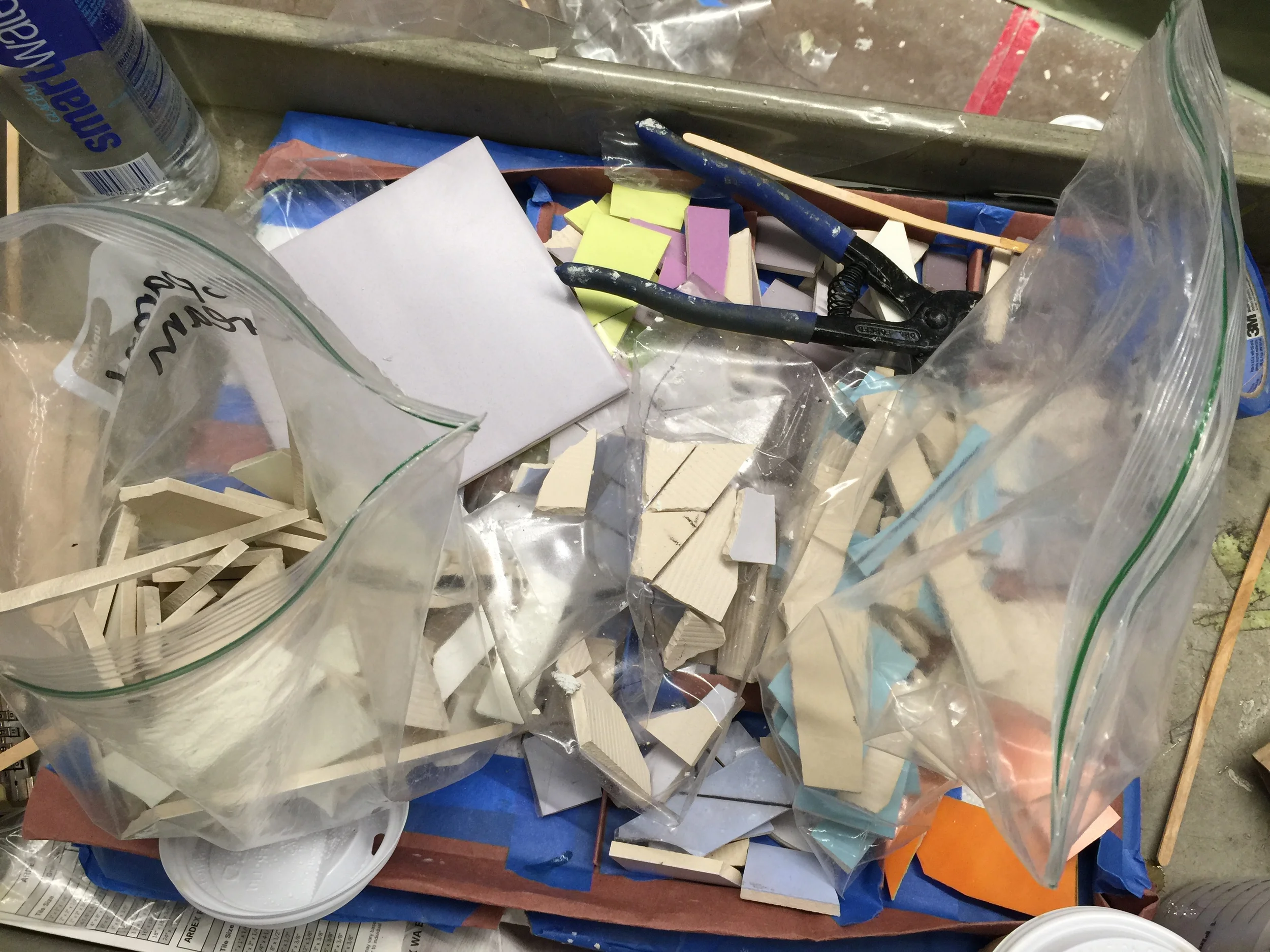 The team has a supply of tile in every color. Small pieces are cut and placed as necessary, replacing those that may have fallen out during the installation.