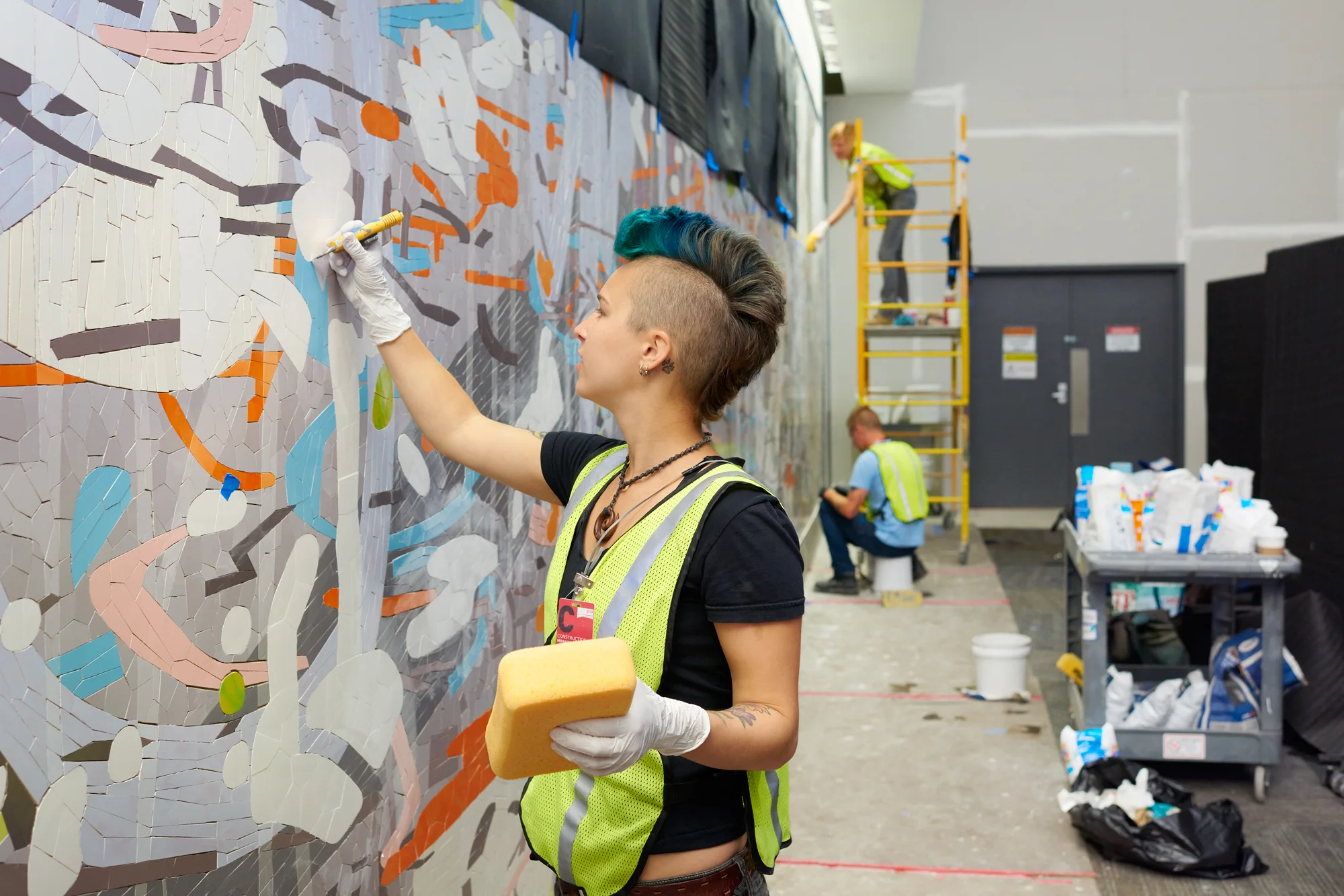 Jessica joined the team after Valentina departed last week. She carefully cleans grout from a grout line intended for another color. 