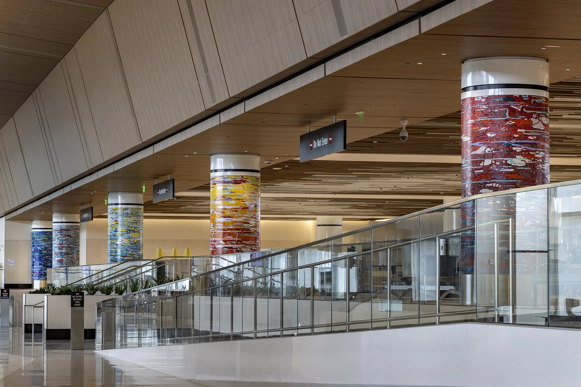 A Day in the Sun , 2025 Glass mosaic on six columns, terrazzo floor Each 54 inches in diameter, 120 inches high New Terminal 1 San Diego International Airport