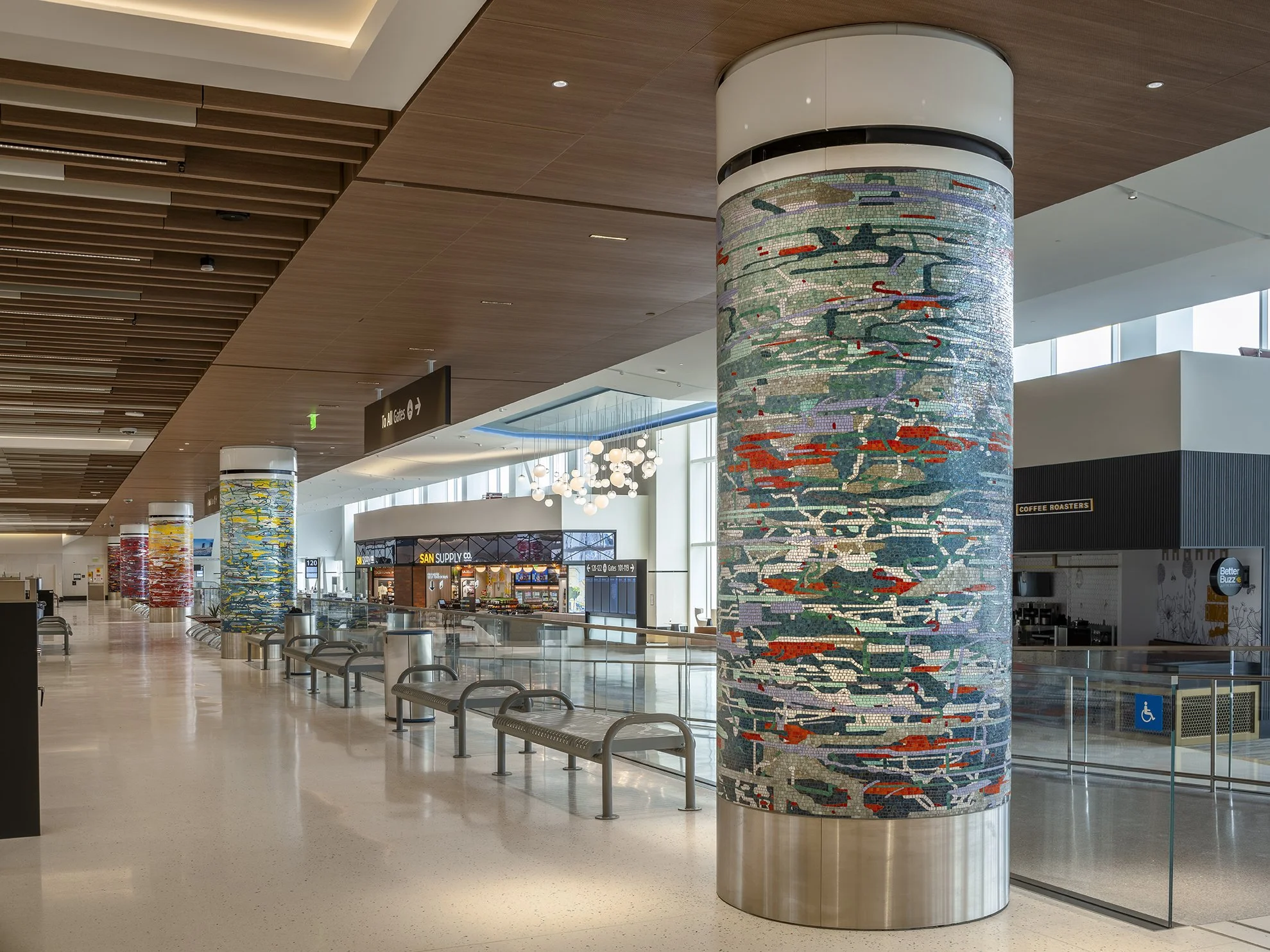 A Day in the Sun , 2025 Glass mosaic on six columns, terrazzo floor Each 54 inches in diameter, 120 inches high New Terminal 1 San Diego International Airport