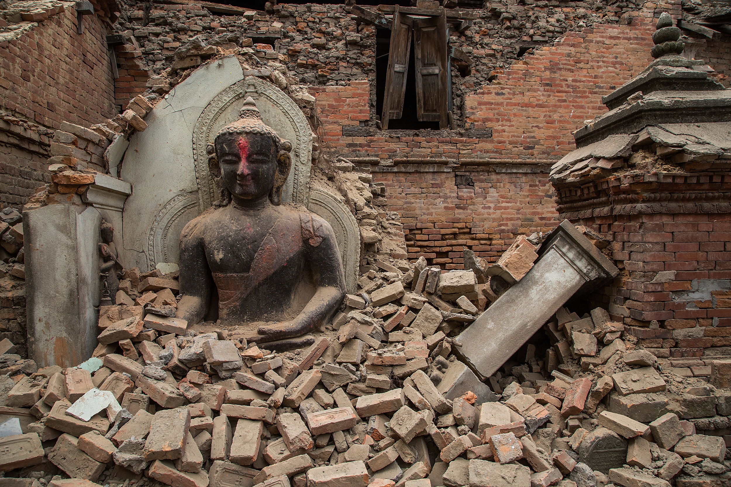 A Buddha statue is surrounded by debris from a collapsed temple in the UNESCO world heritage site of Bhaktapur on April 26 in Bhaktapur, Nepal.&nbsp;(Photo: Omar Havana, Getty Images)