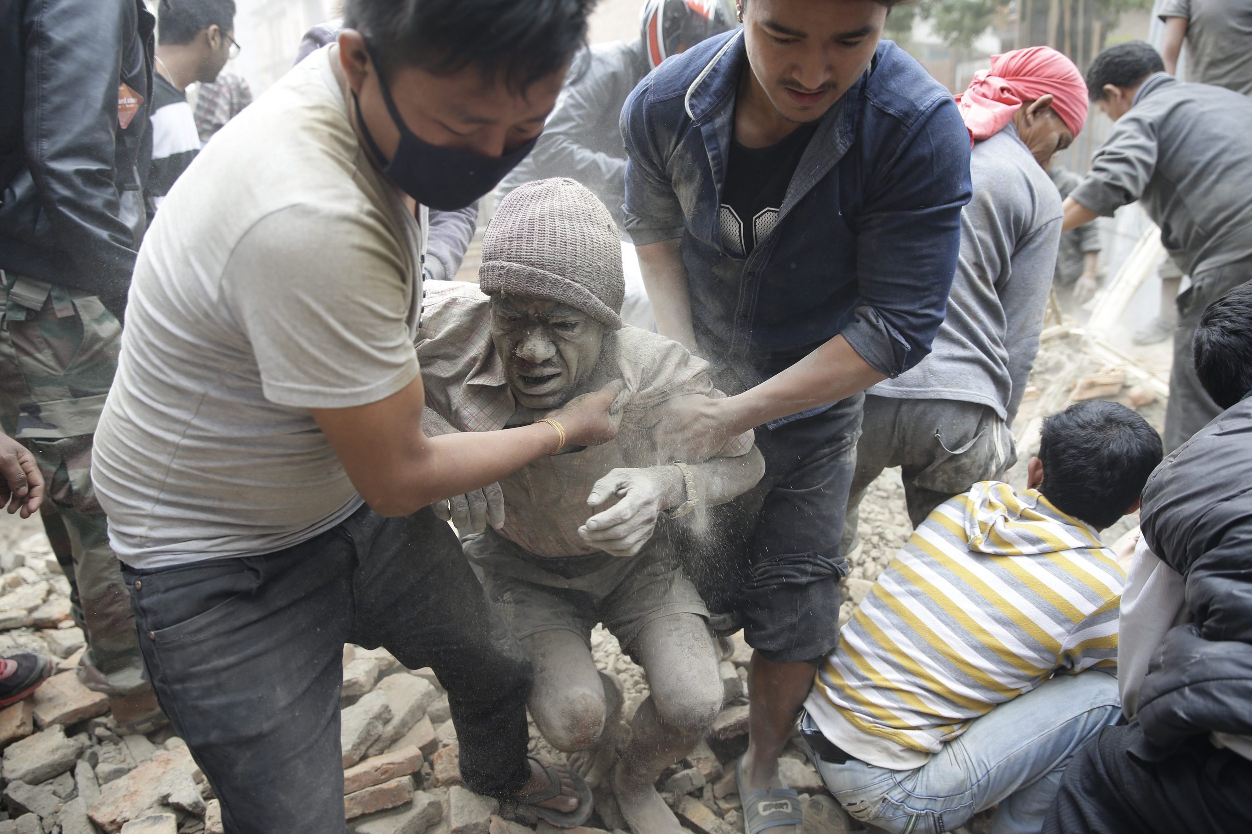 People free a man from the rubble of a destroyed building.&nbsp;(Photo: Narendra Shrestha, European Pressphoto Agency)