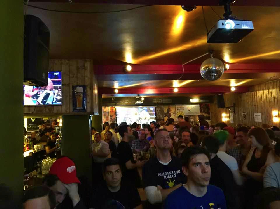 The crowd anxiously watches the fight&nbsp;at The Keg Bar