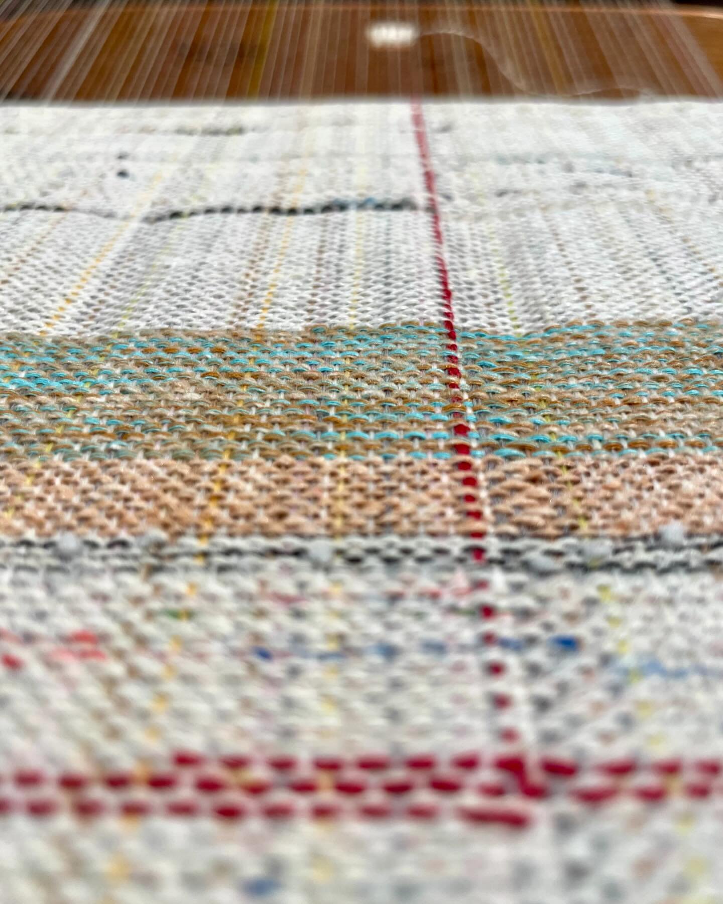 I&rsquo;ve been working away at the loom this month and playing with my serger. Loving every minute I get to spend in my new studio!

In the first photo you can see wear I added in a supplemental warp thread in red. I get a kick out of adding in bold