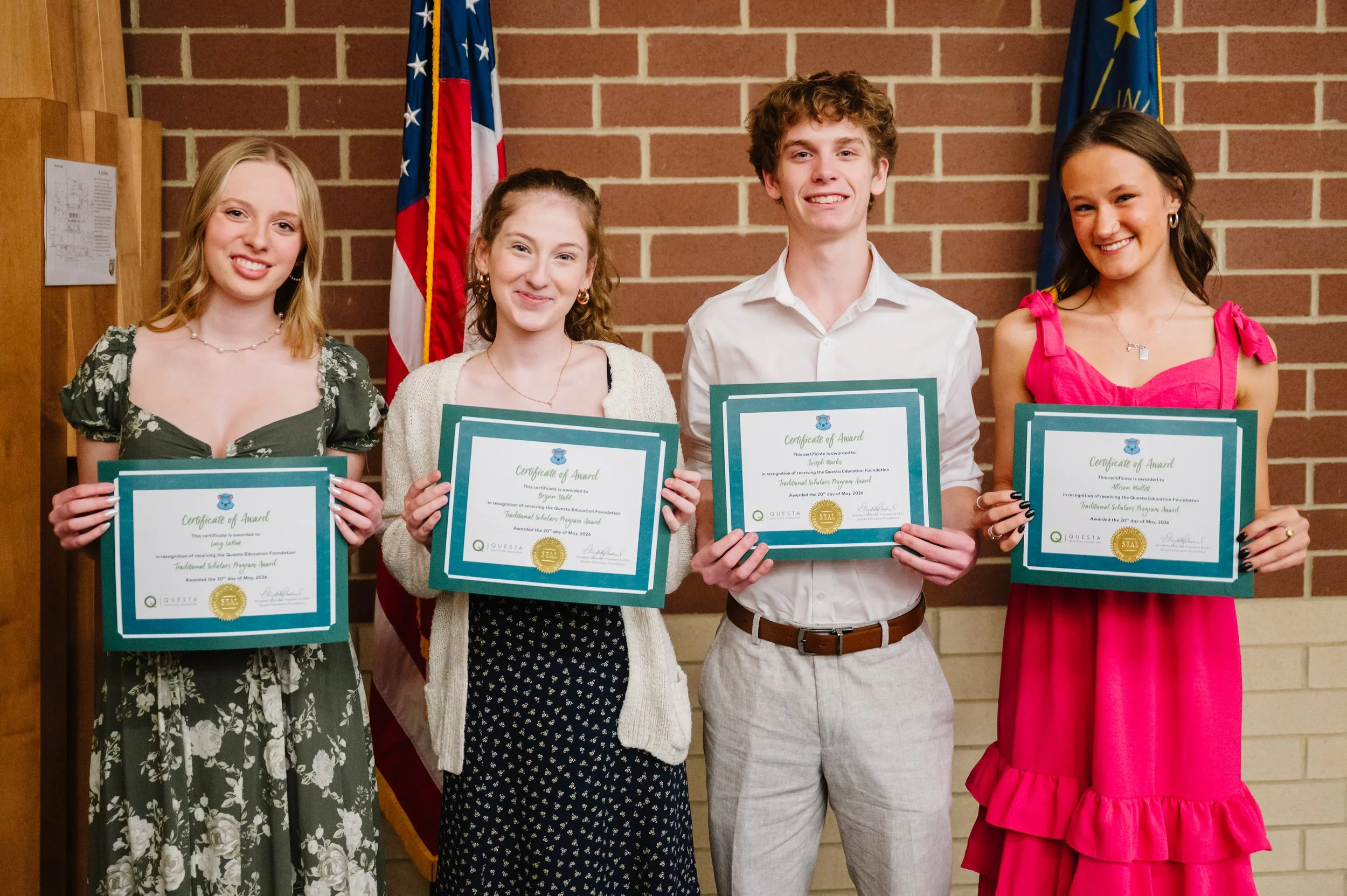 Four Columbia City High School students receive their Questa Scholars award certificates.
