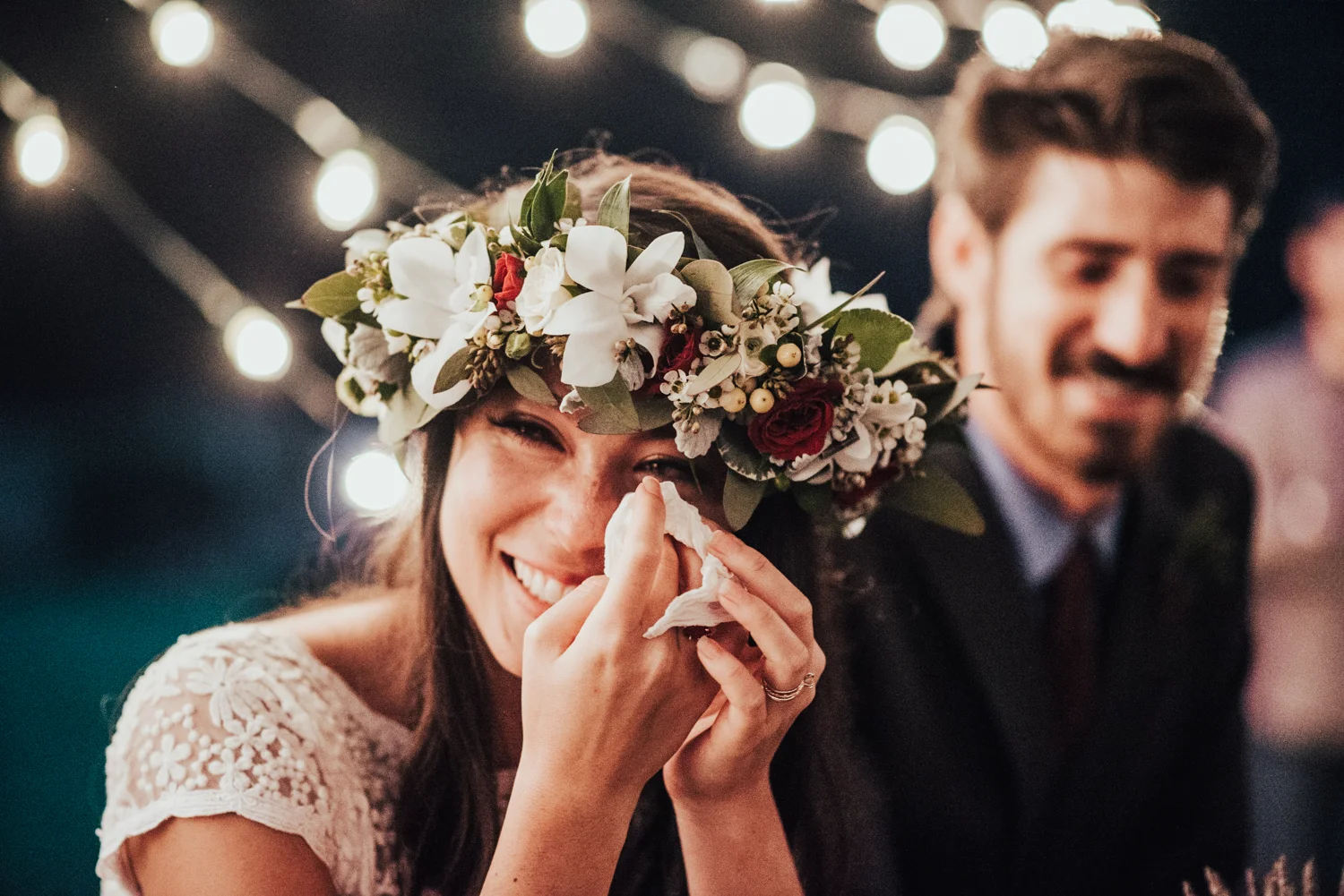 Boho bride with flower crown crying during toasts photographed by Big Sur Wedding Photographers Tessa Tadlock 