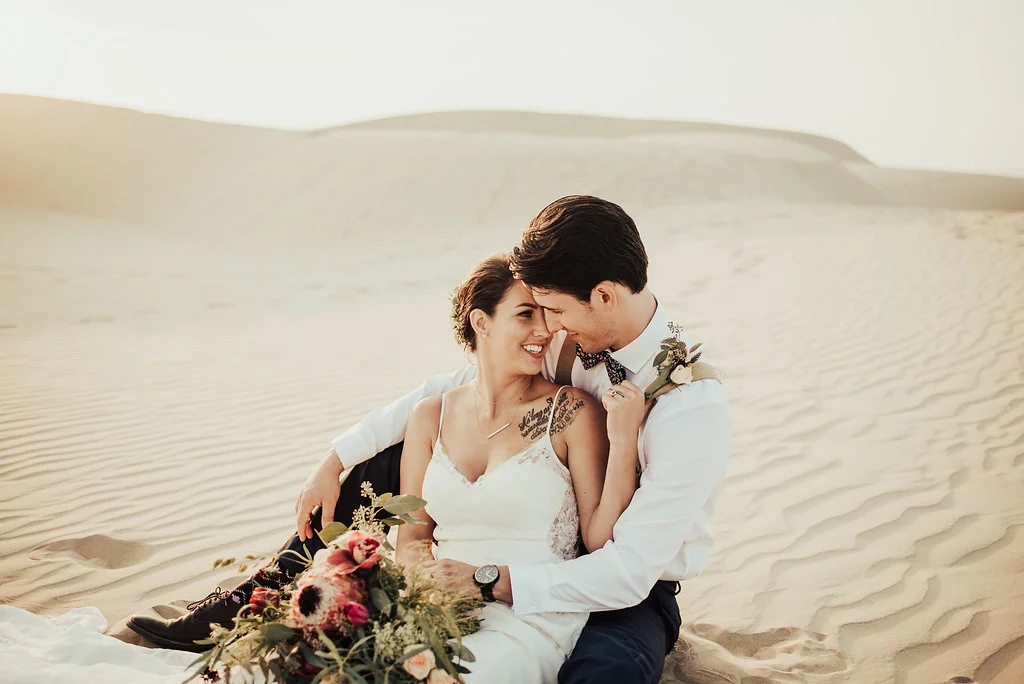 Boho Bride &amp; Groom on White Sand Dunes with Wildflower Bouquet Photographed by Big Sur Wedding Photographers Tessa Tadlock