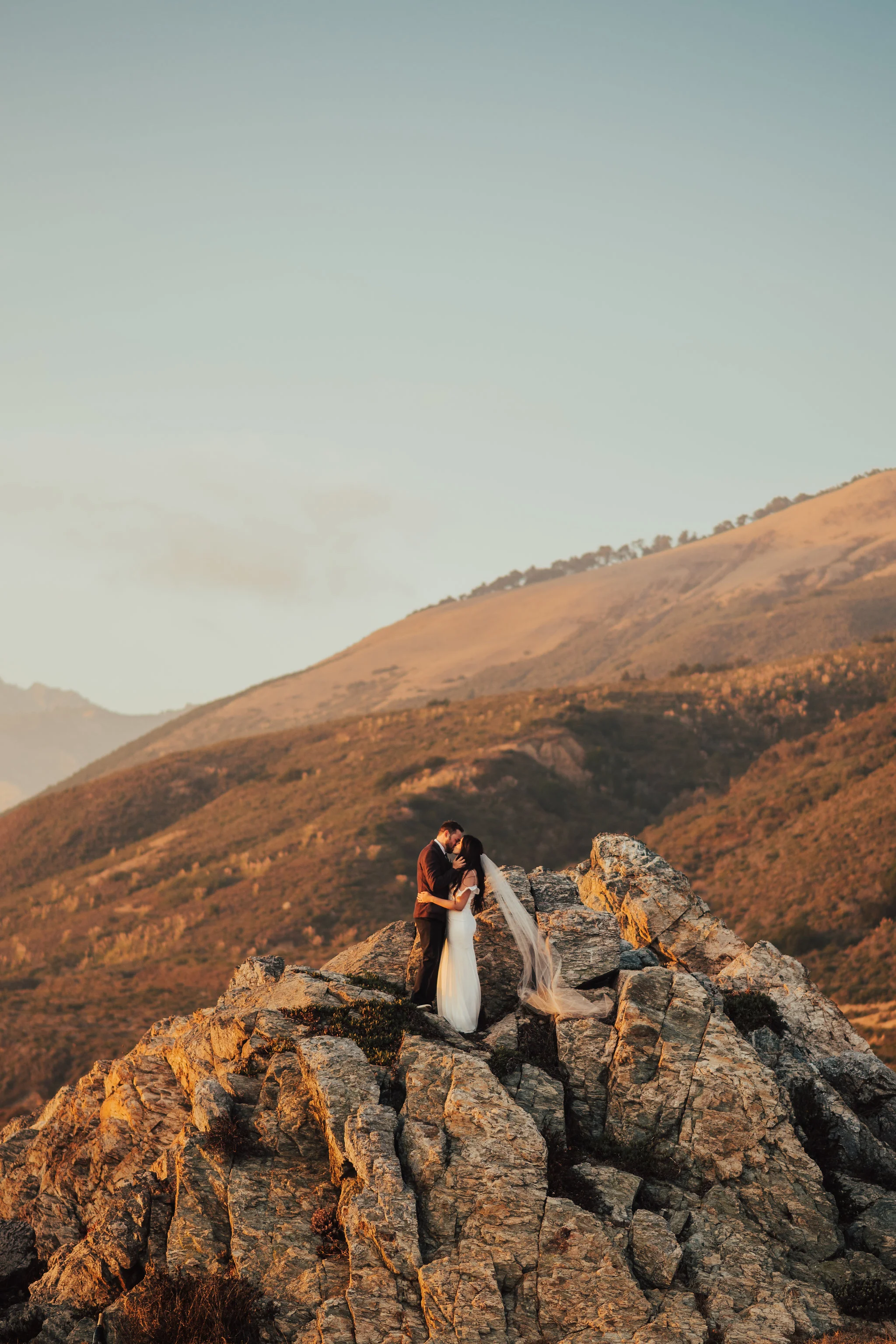 Bride &amp; Groom rock climb on Big Sur coast photographed by Big Sur Wedding Photographers Tessa Tadlock 