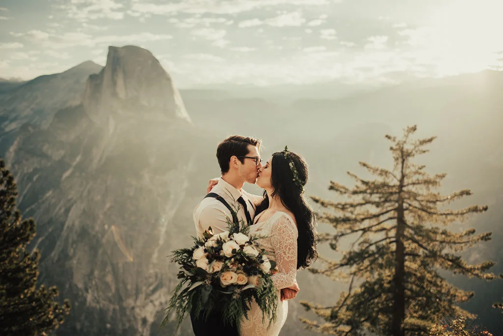 Bride &amp; Groom Share Kiss with Breathtaking View of Yosemite Photographed by Big Sur Wedding Photographers Tessa Tadlock
