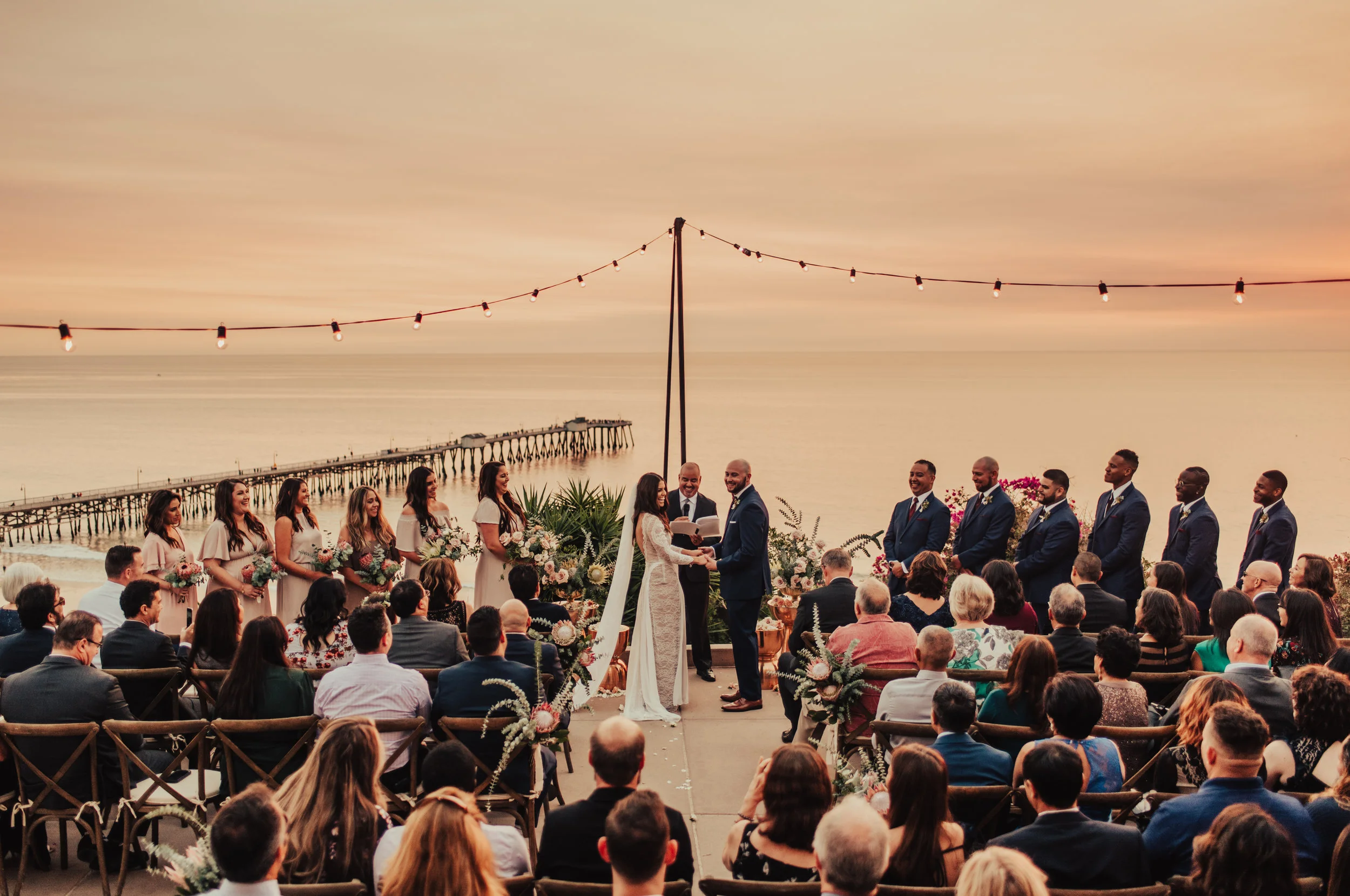 Stunning waterfront wedding at sunset photographed by Big Sur Wedding Photographers Tessa Tadlock 