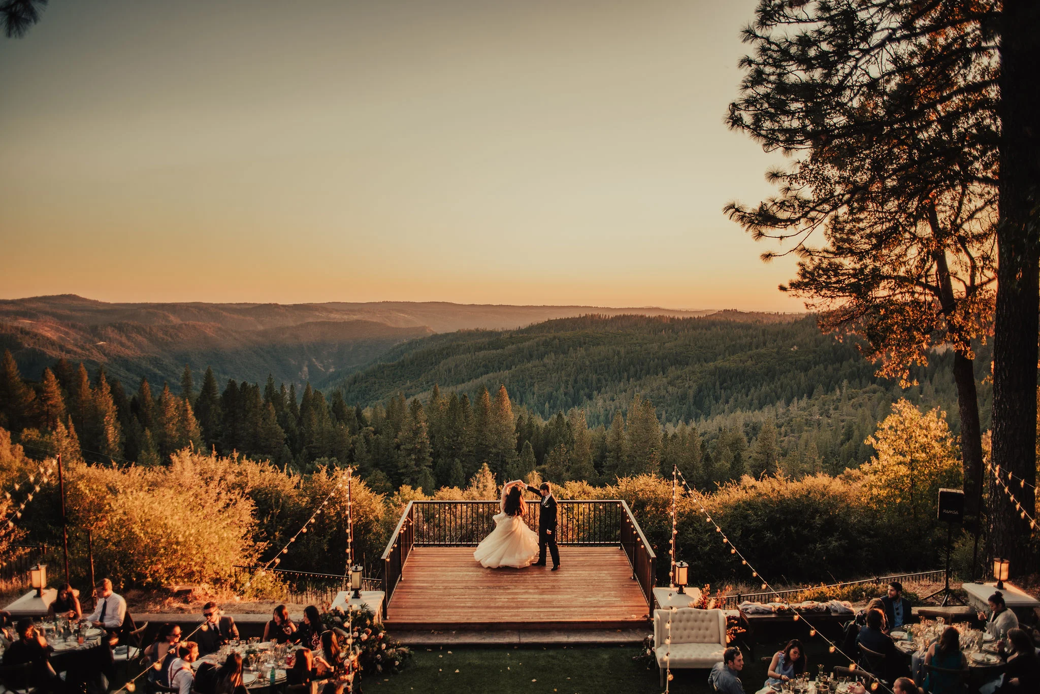 Bride &amp; groom first dance at sunset during outdoor wedding reception photographed by Big Sur Wedding Photographers Tessa Tadlock