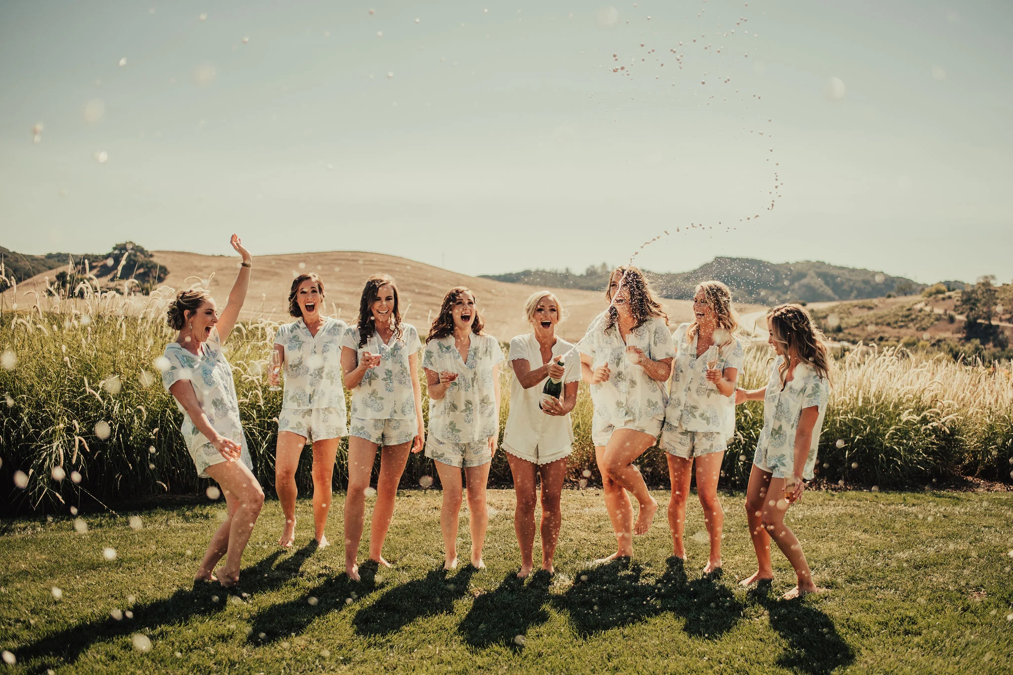 Bridal Party Pops Champagne Photographed by Big Sur Wedding Photographers Tessa Tadlock 
