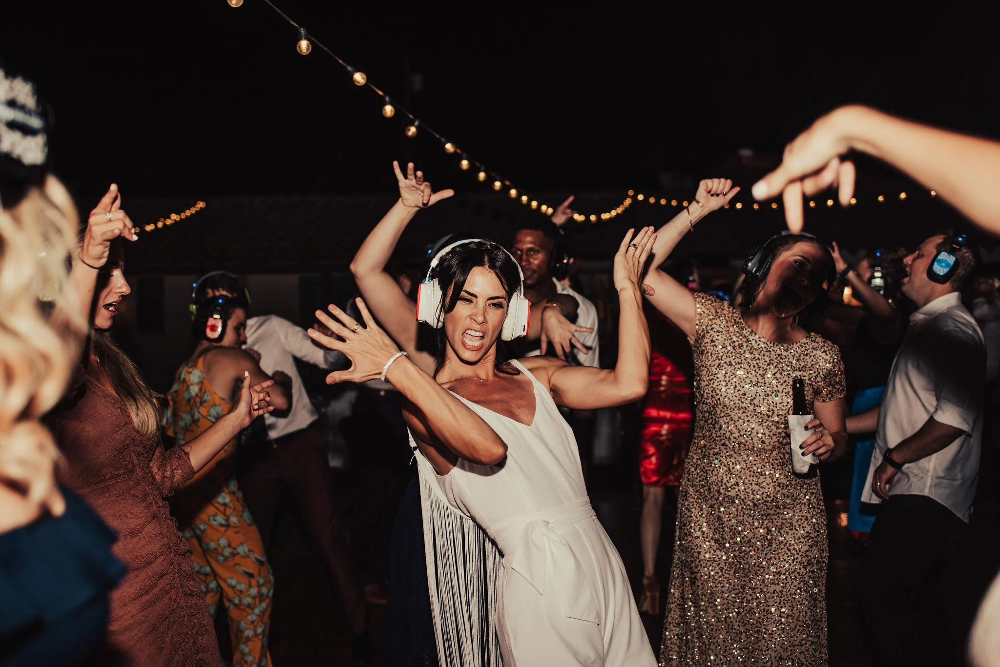 Modern Bride Dances during Silent Disco Reception Photographed by Big Sur Wedding Photographers Tessa Tadlock
