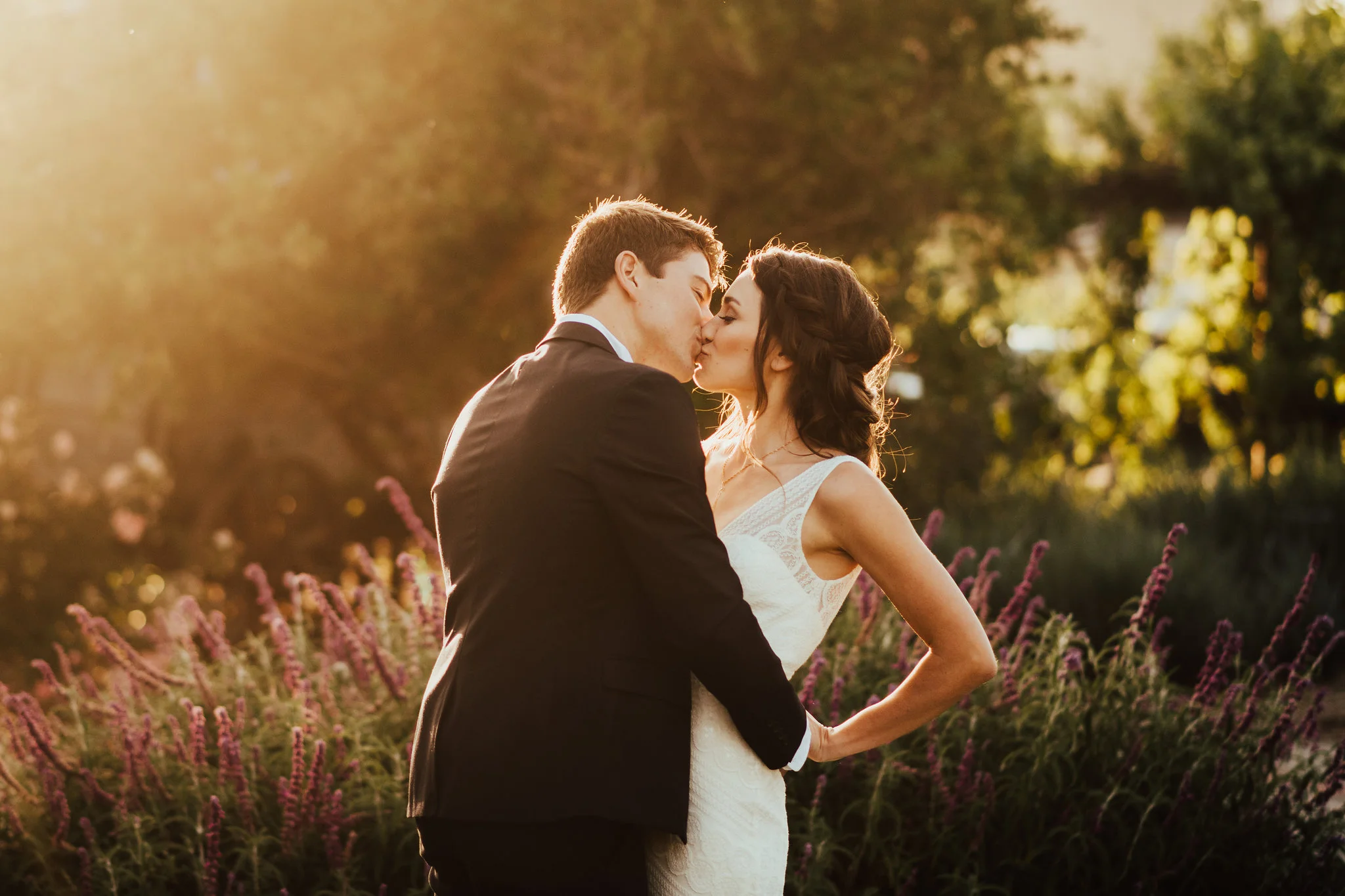 Golden Hour Portrait of Groom &amp; Bride in Wildflower Field Photographed by Big Sur Wedding Photographers Tessa Tadlock