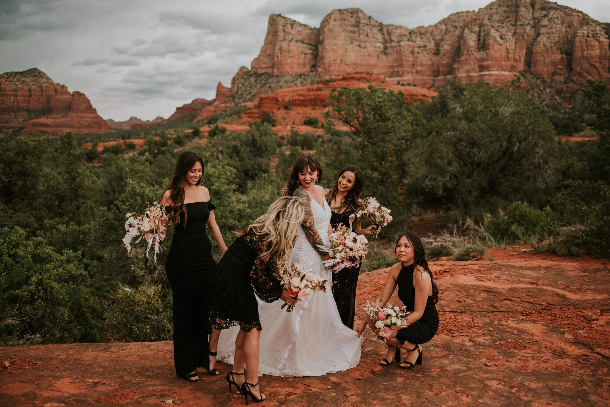 Bridesmaids in Black Dresses Help Boho Bride for Portraits Photographed by Big Sur Wedding Photographers Tessa Tadlock