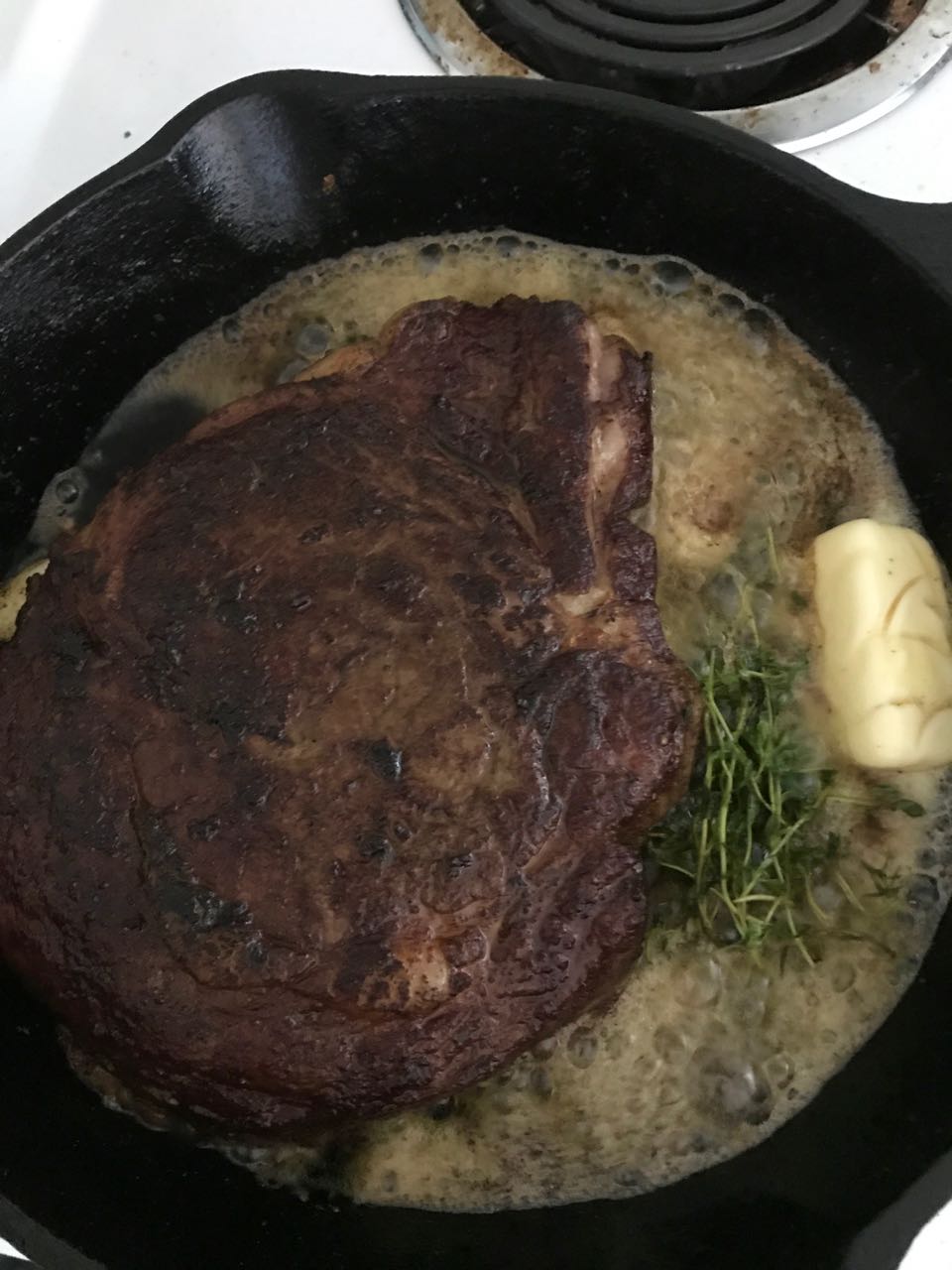 searing ribeye with butter thyme and garlic.jpg