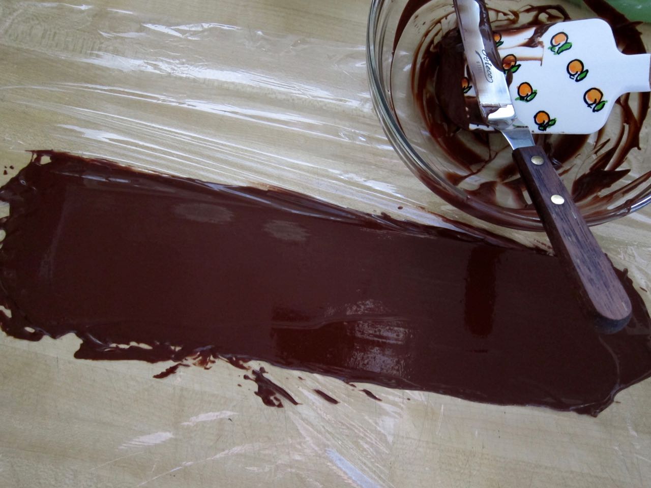Spreading tempered chocolate on acetate.jpg