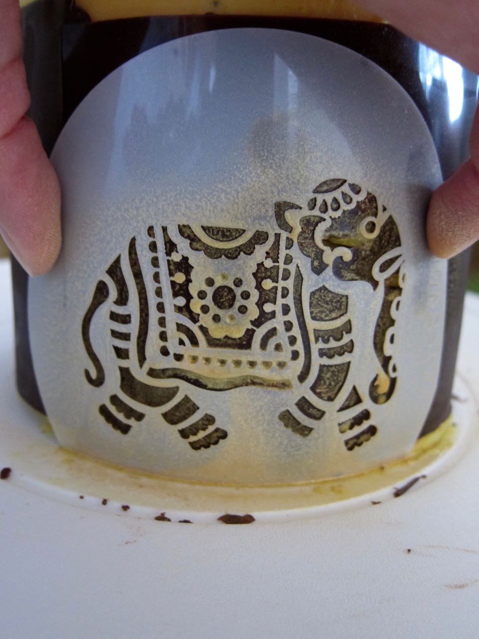 Applying gold spray with Elephant stencil.jpg