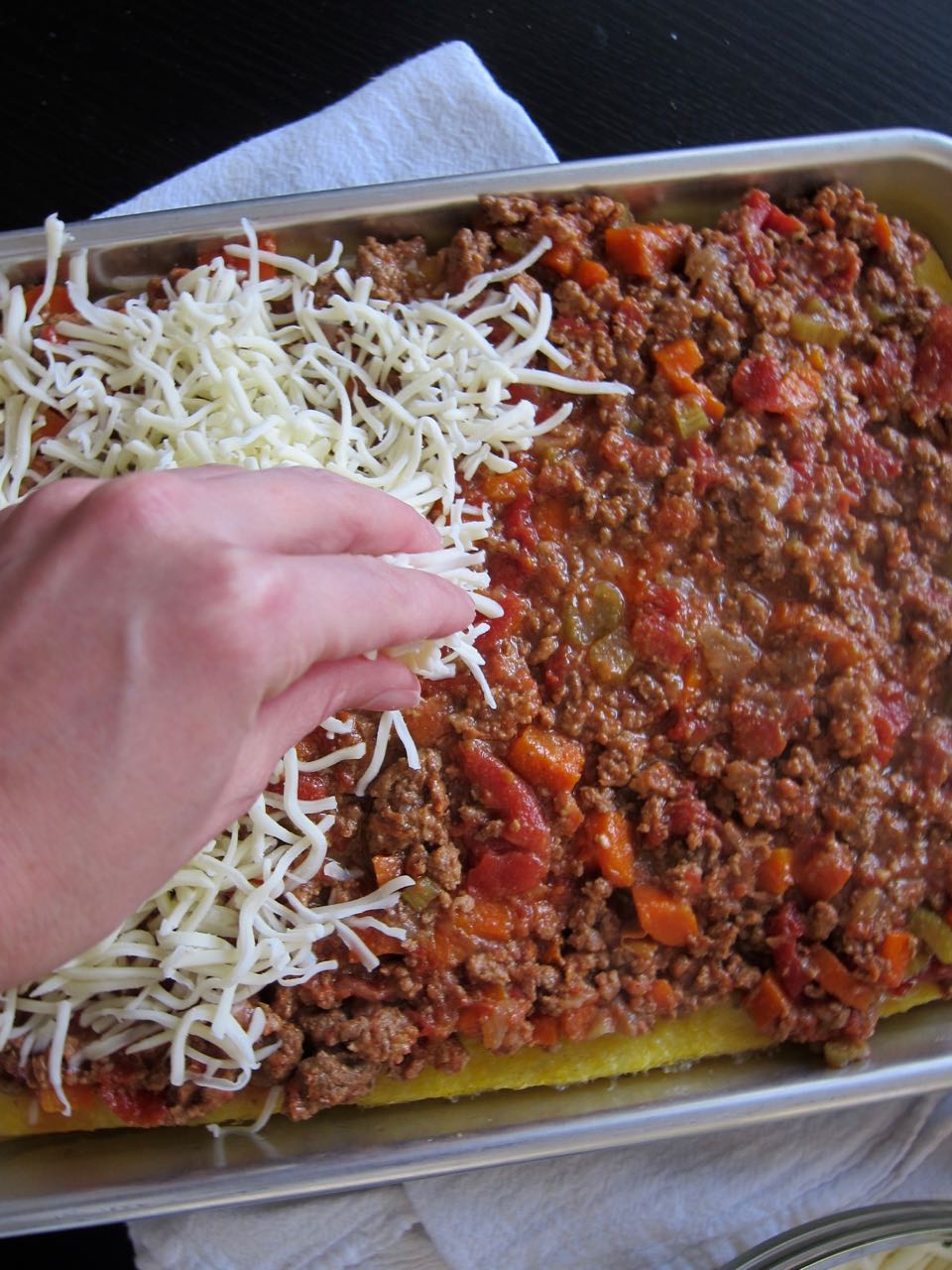 laying cheese on polenta pizza.jpg