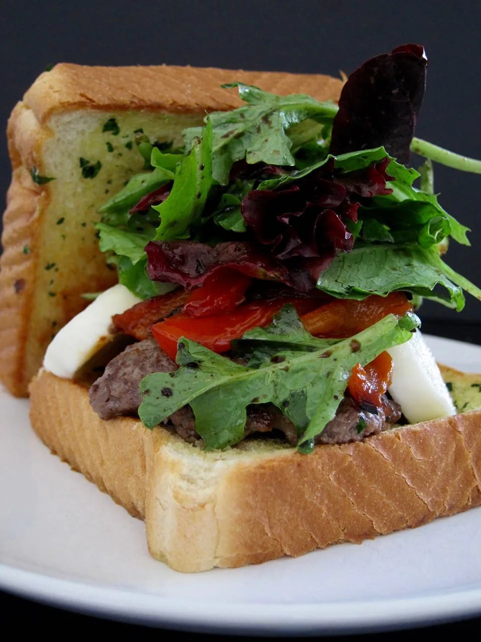 bruschetta burger on thick garlic toast