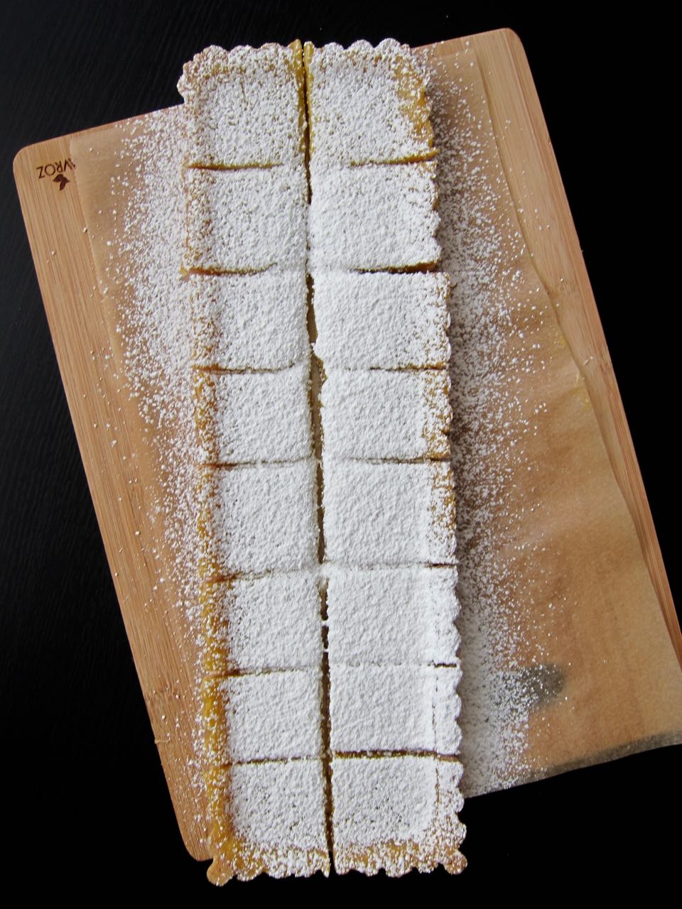 lemon tart squares dusted in powdered sugar.jpg
