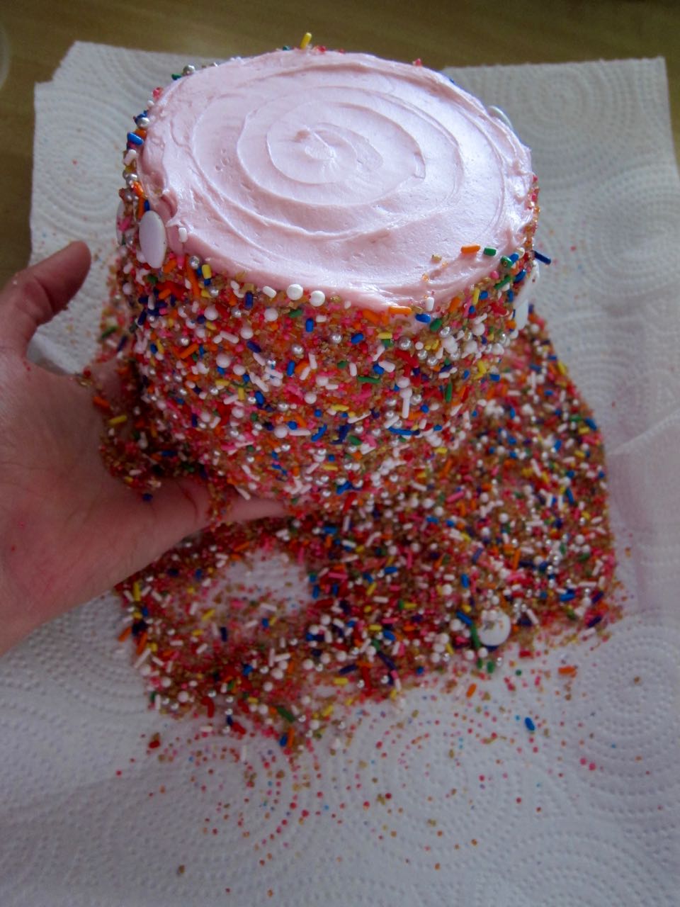 Coating a cake in sprinkles.jpg