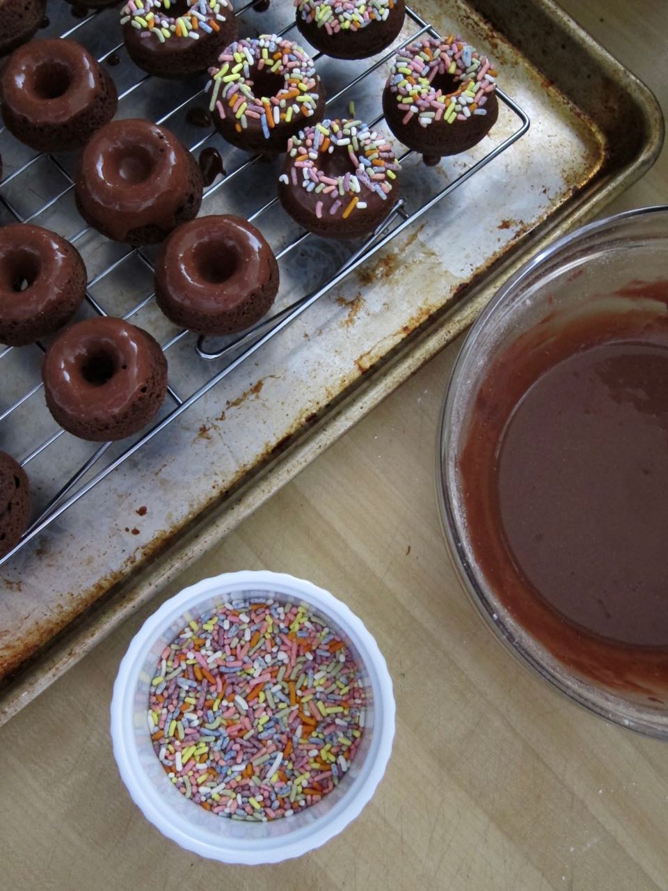 glazing and decorating mini chocolate donuts.jpg