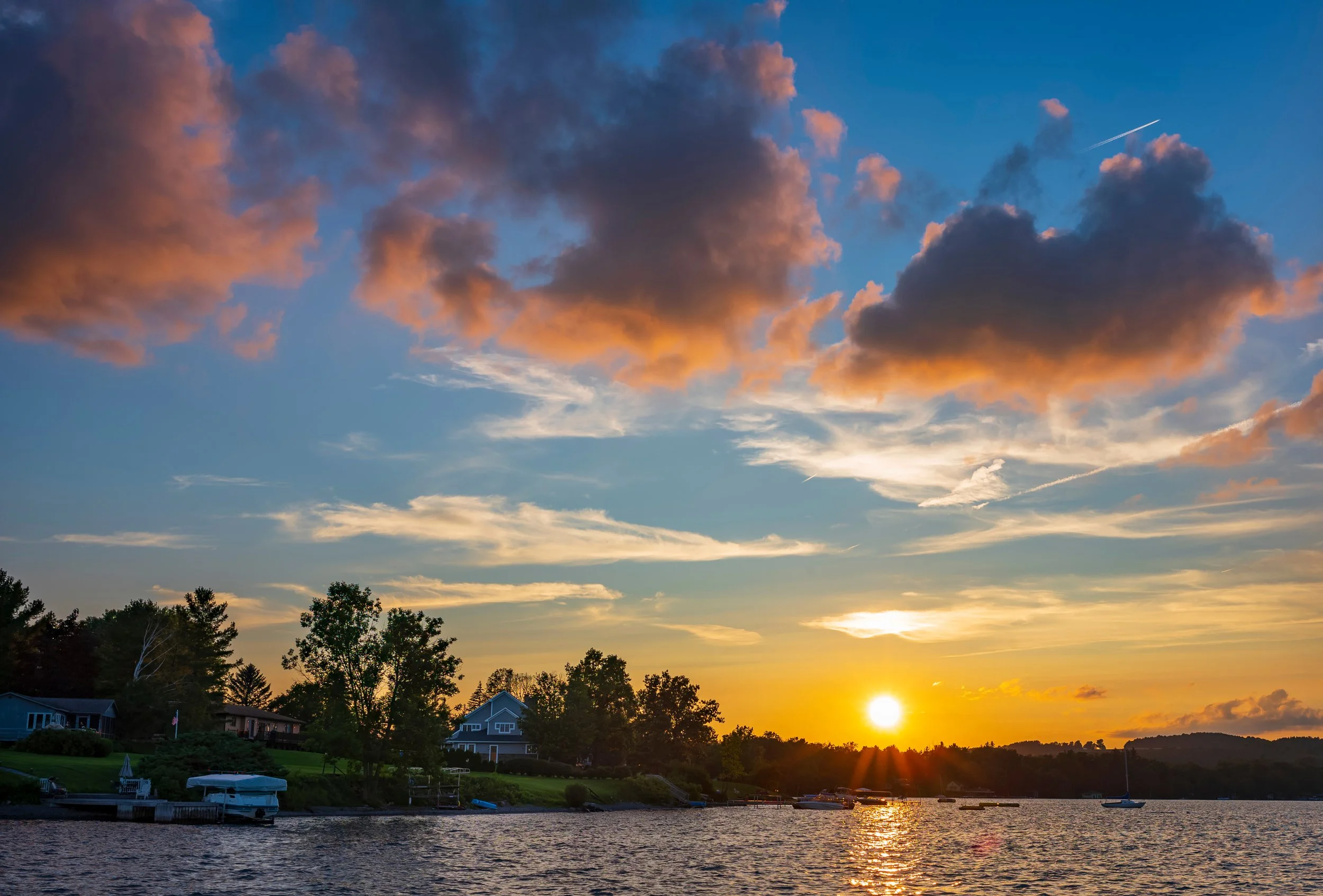 Beautiful sunset over Skaneateles Lake showcasing luxury Finger Lakes living in Central New York.