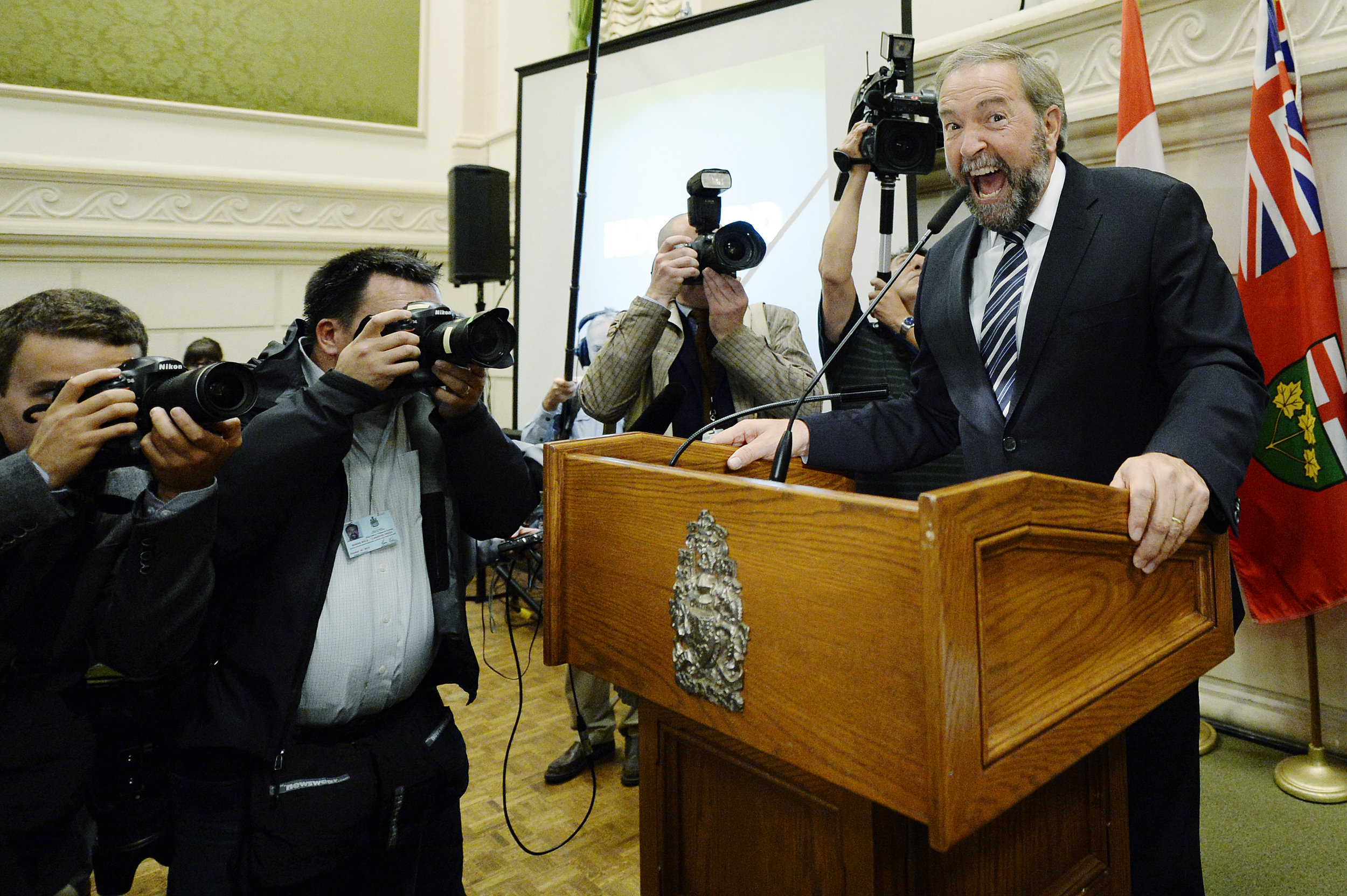 The leader of New Democratic Party of Canada Tom Mulcair cheers on the party members during NDP Caucus meeting. NDP has opened their doors to the media when they boycotted Conservative Party's caucus meeting.