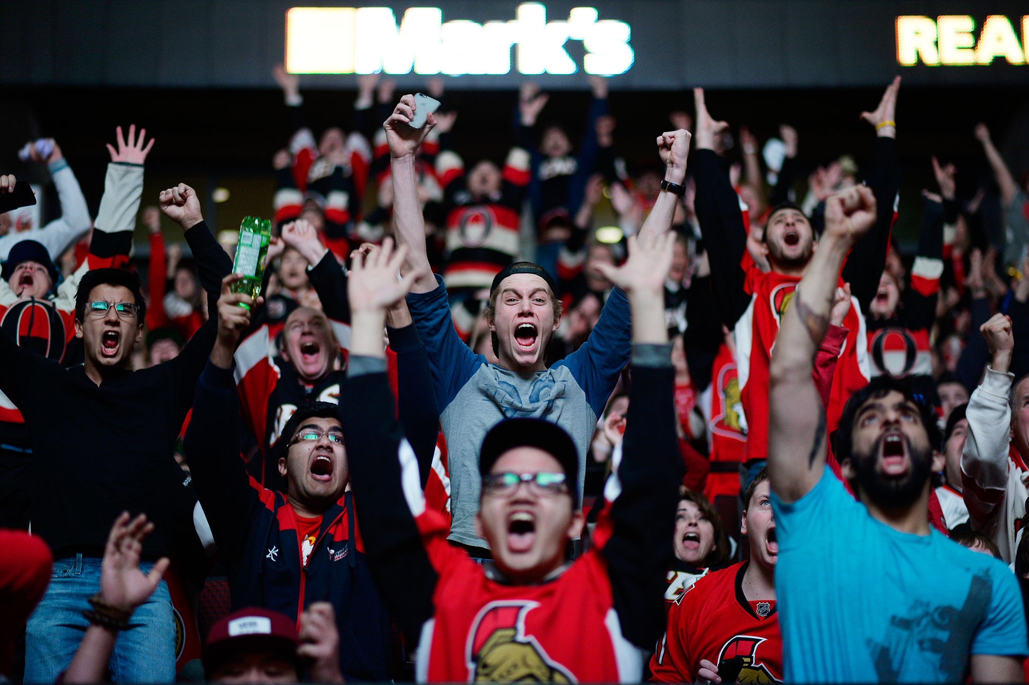  Ottawa Senators fans cheers as the team score the second goal against Philadelphia Flyers and clinch the playoff spot. Fans watched the game on the big screen at Canadian Tire Centre on Saturday, April 11, 2015. 