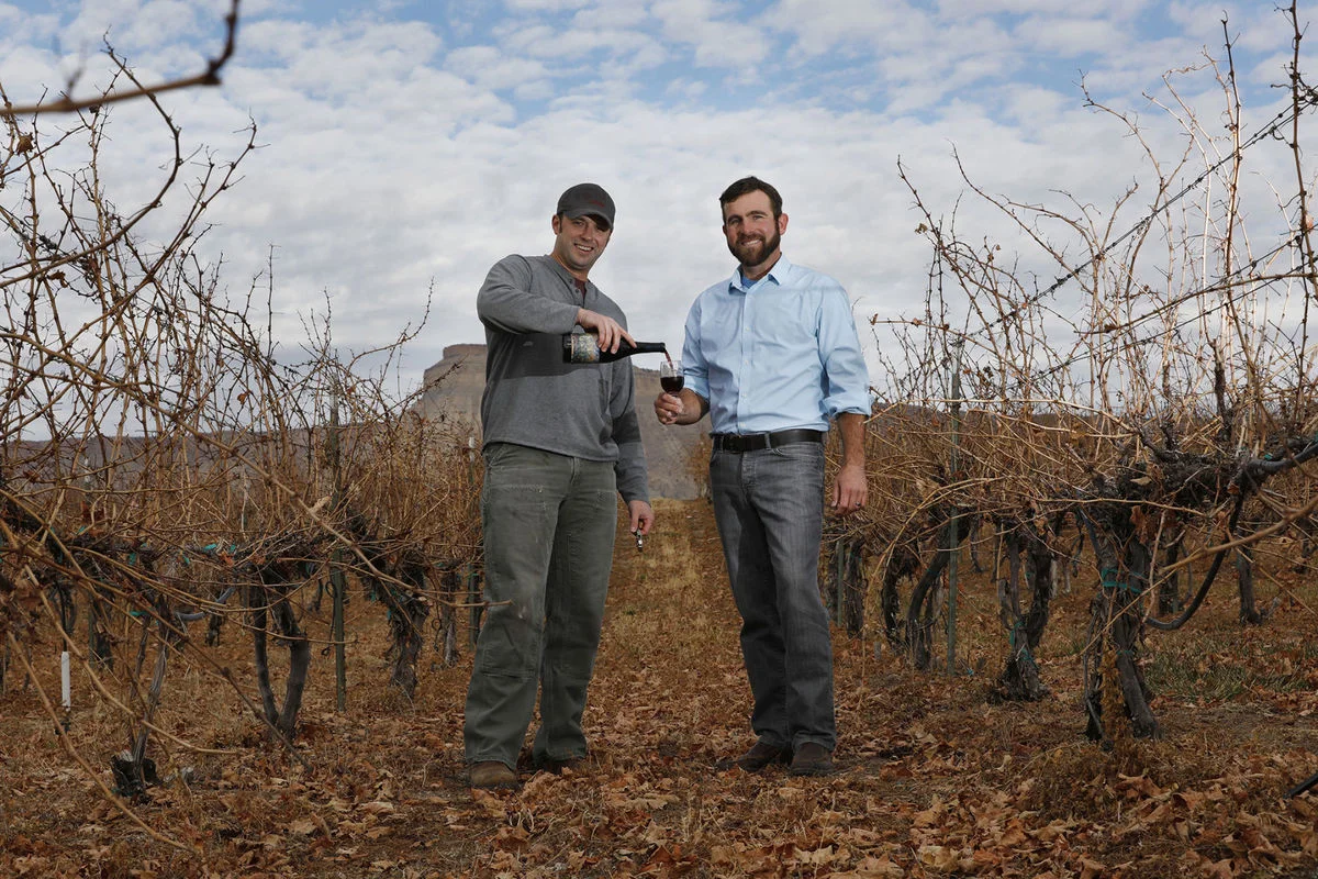 Garrett Portra, left, new owner of Carlson Vineyards in Palisade, and Joe Neuhof, executive director of Colorado Canyons Association, recently partnered to serve Portra's new red wine blend, River's Edge, as a fundraiser for the nonprofit association, which cares for three Grand Valley national conservation areas.