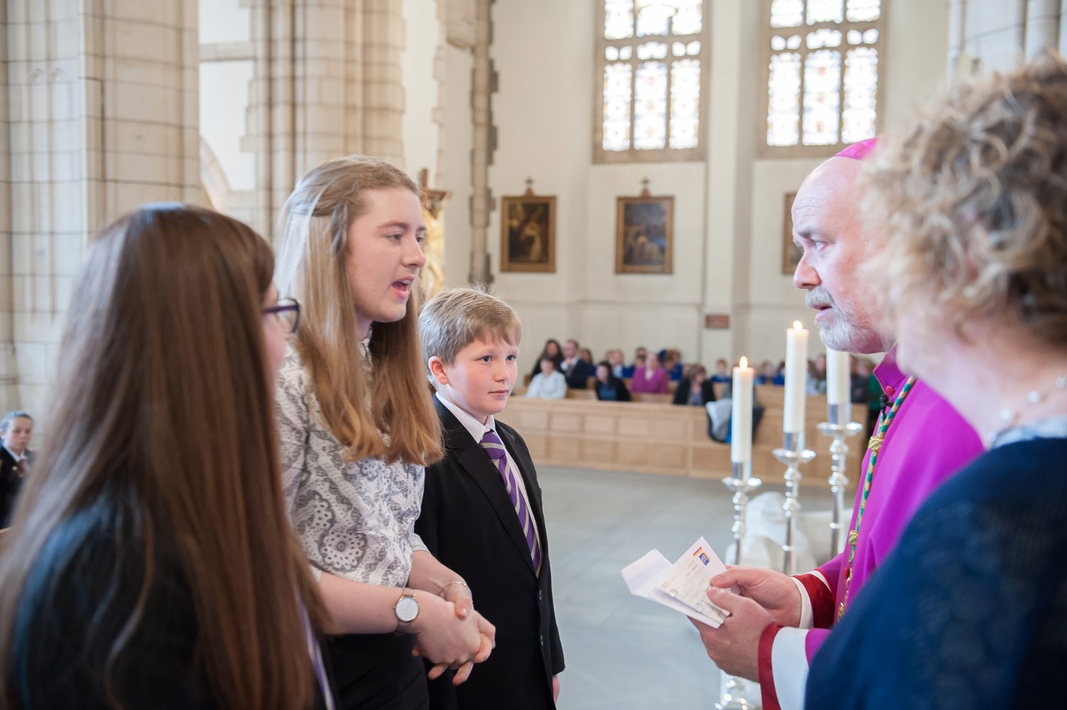 Photo: Antonia Karimi (7 Wharton), Ella Humphreys (Year 12) and Kyle Deighton (7 More) present our school community's cheque to Bishop Marcus.