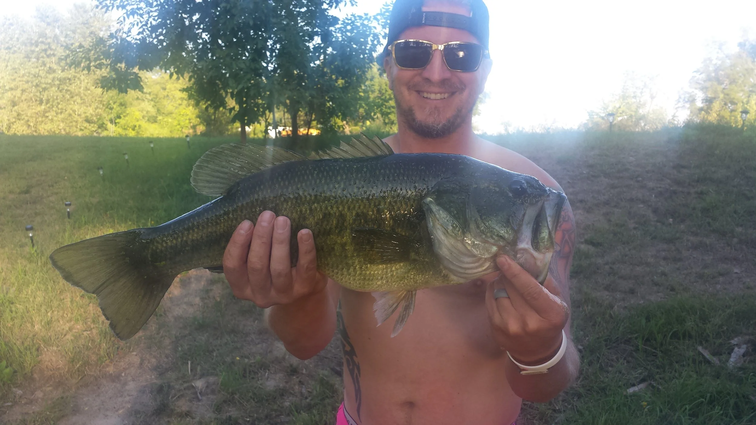 Brett hooking a big one out of our pond that has an impressive combination of both length and girth.