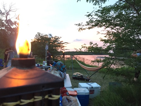 Some tiki torches, a hammock, some nice music, hugs, coolers of beer, food...pretty much everything you could ask for in 1 picture.