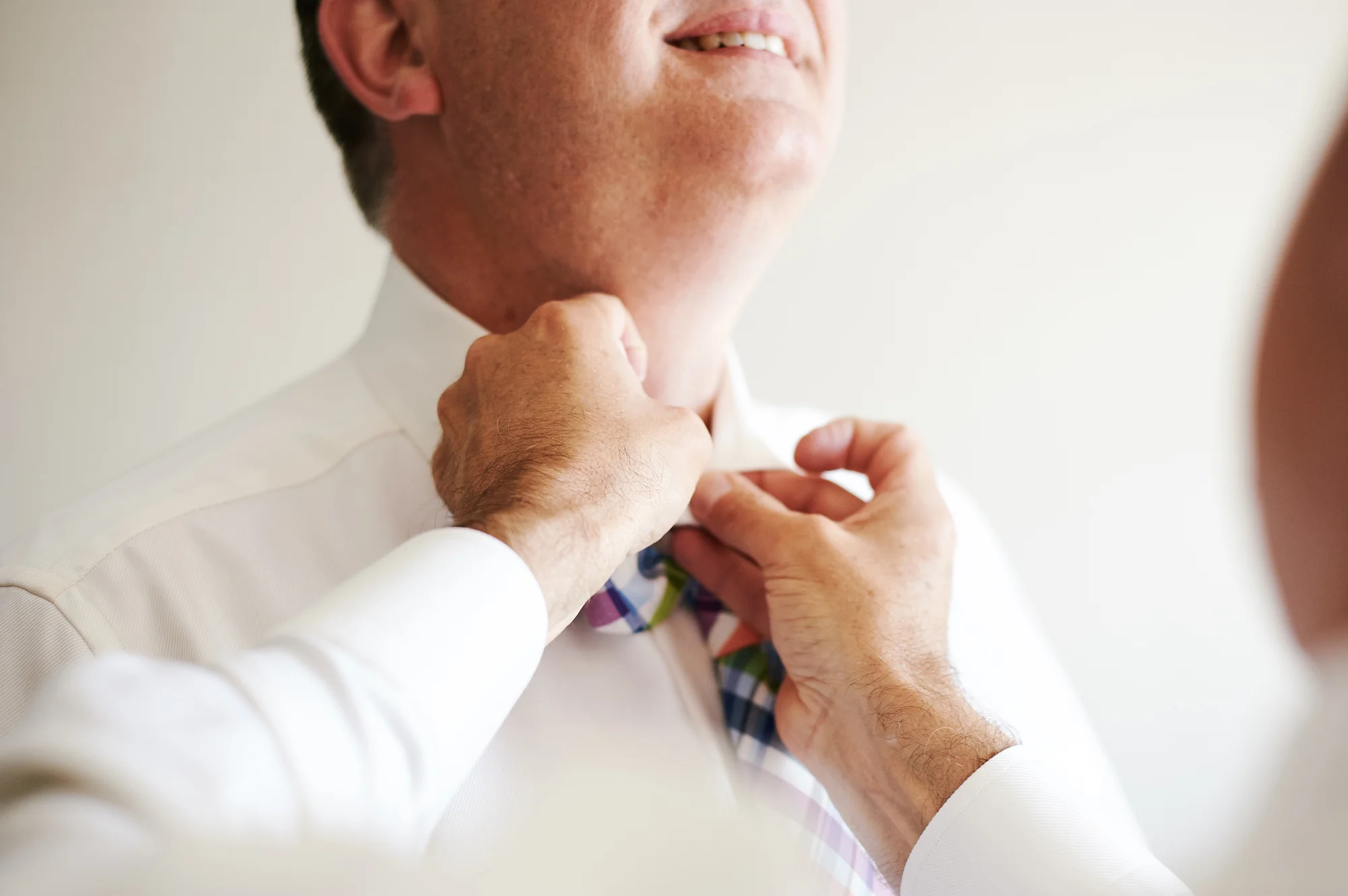 Groomsmen tying a tie