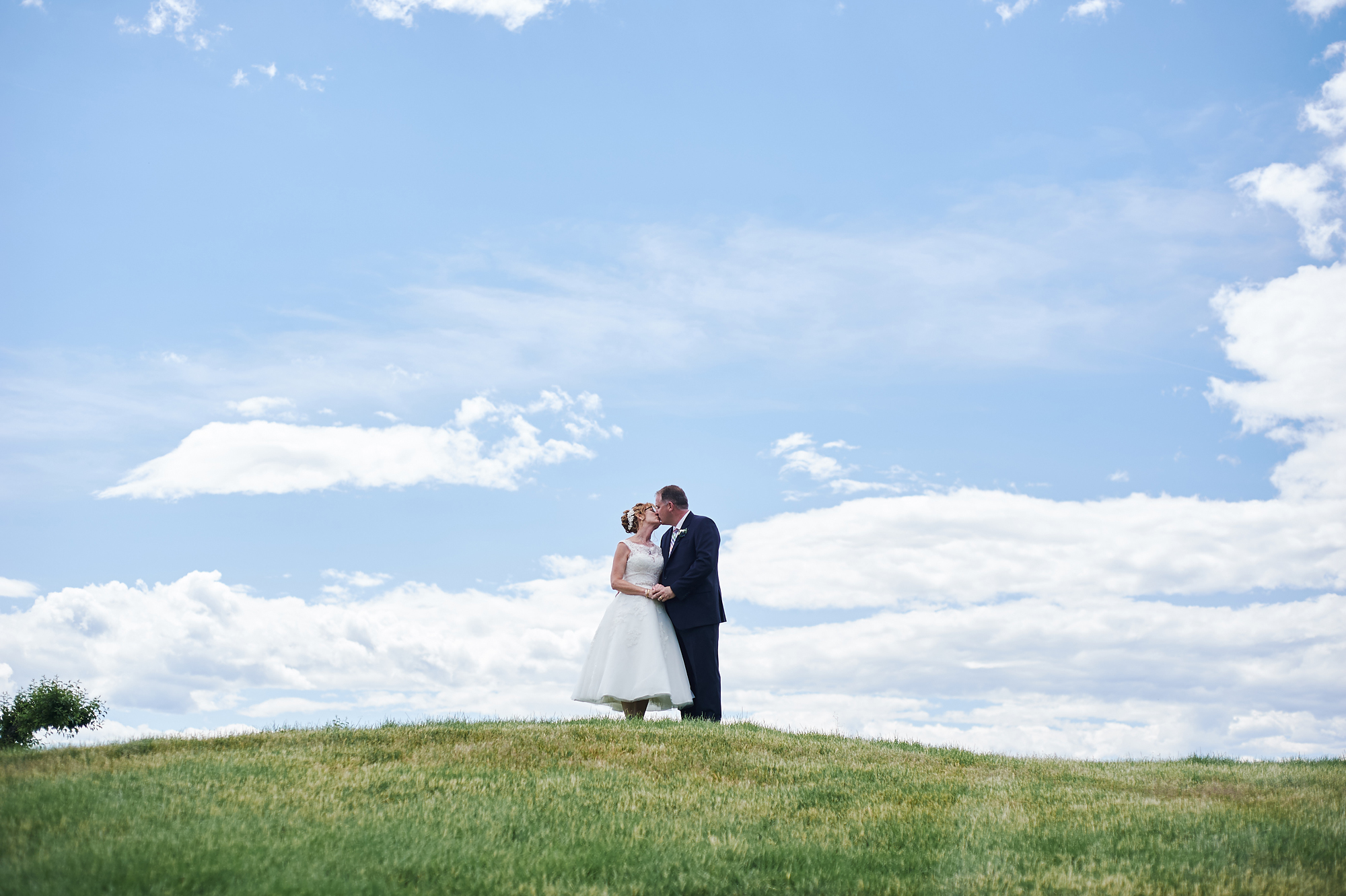 wedding portrait against blue sky