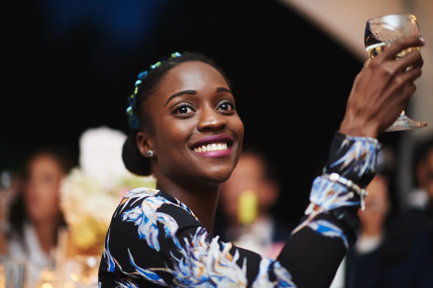 ethnic woman raise glass in toast