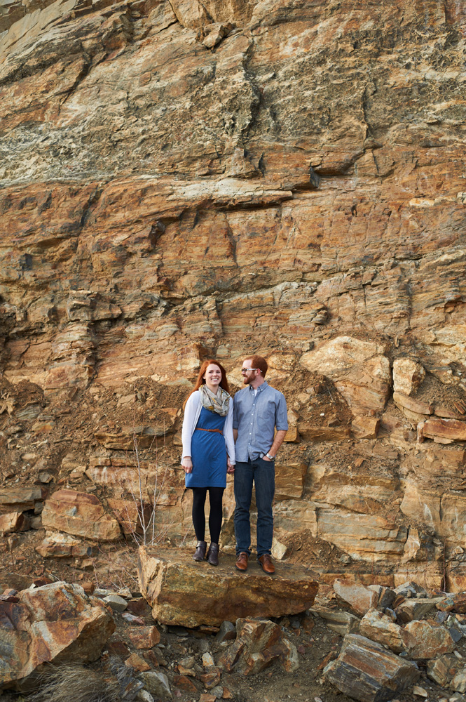 engaged-couple-in-front-of-colored-rock-wall-at-myra-canyon.jpg