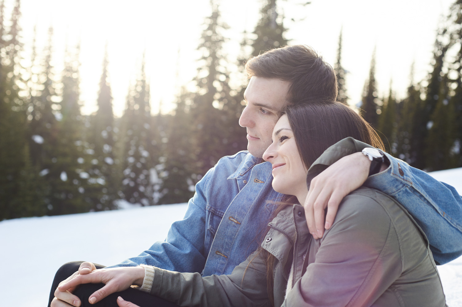 engaged-couple-snuggling-in-the-snow-at-big-white-sunset.jpg