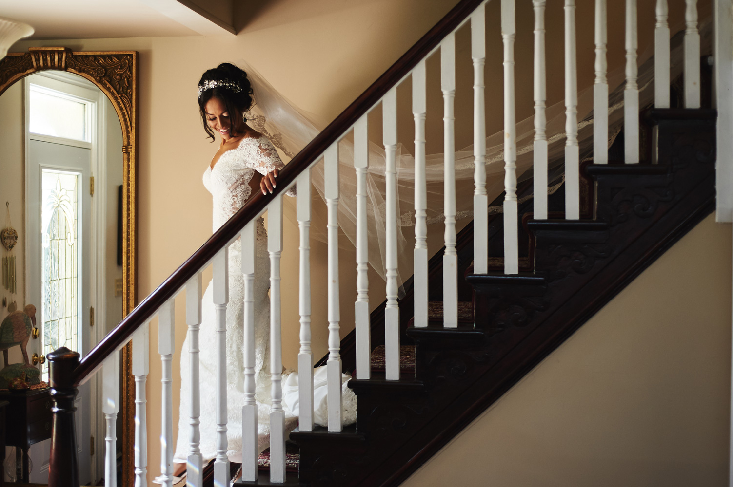 bride-walking-down-the-stairs-veil-trailing.jpg